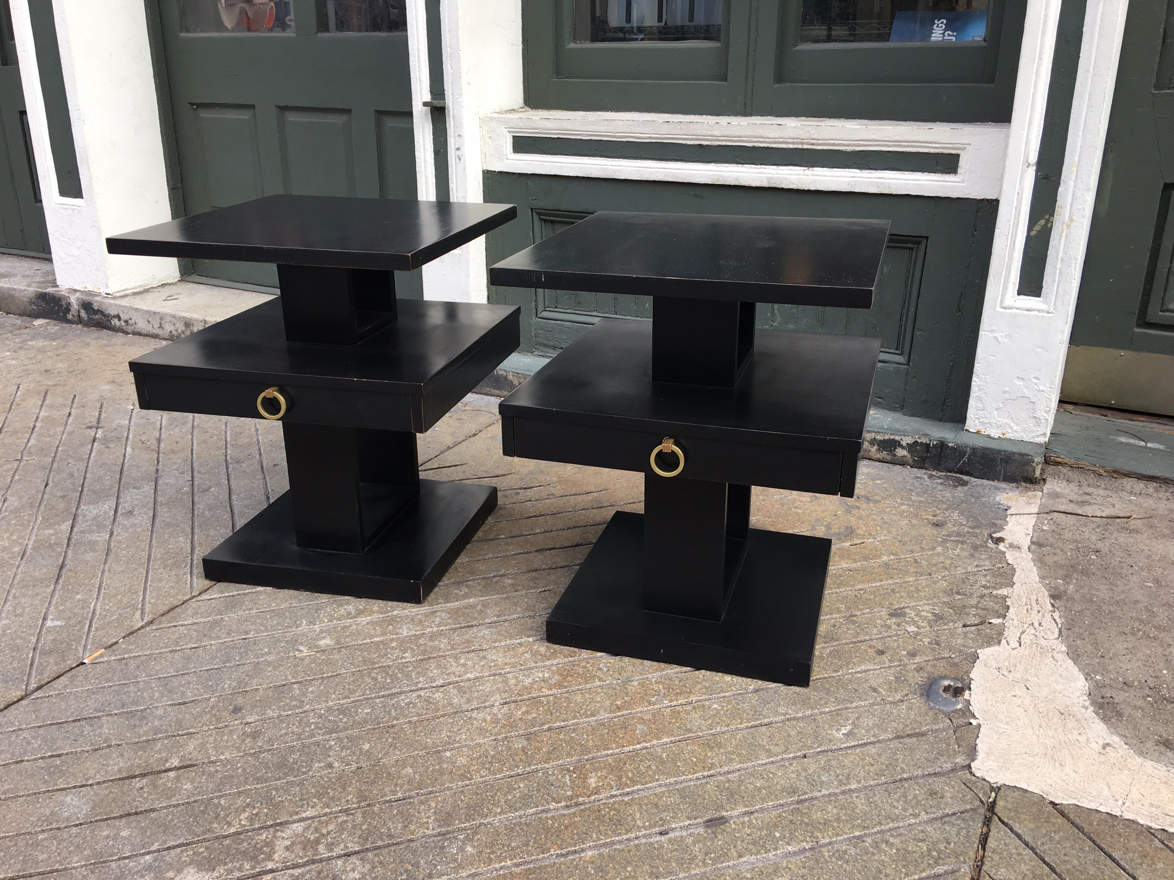 Pair of stacked Lane end tables in a black finish. Black finish shows wear, tables were probably originally bleached mahogany. Unusual tiered design with round brass pull.