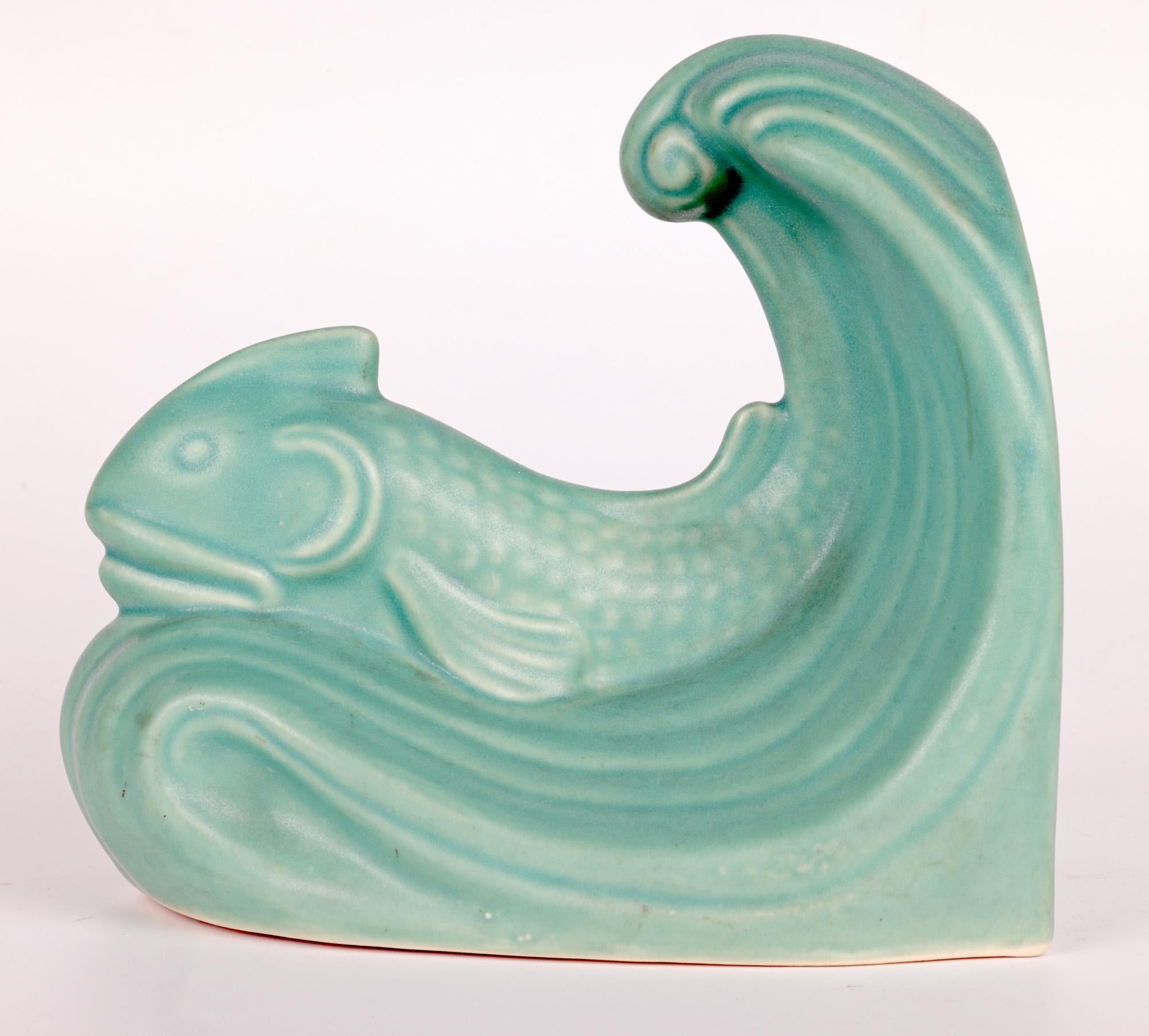 A scarce and wonderful pair Art Deco bookends formed as fish and waves by the Derbyshire based pottery Langley Lovatts and dating from around 1935. Made in the early years of the Oakes period the novelty stoneware bookends are formed as a solitary