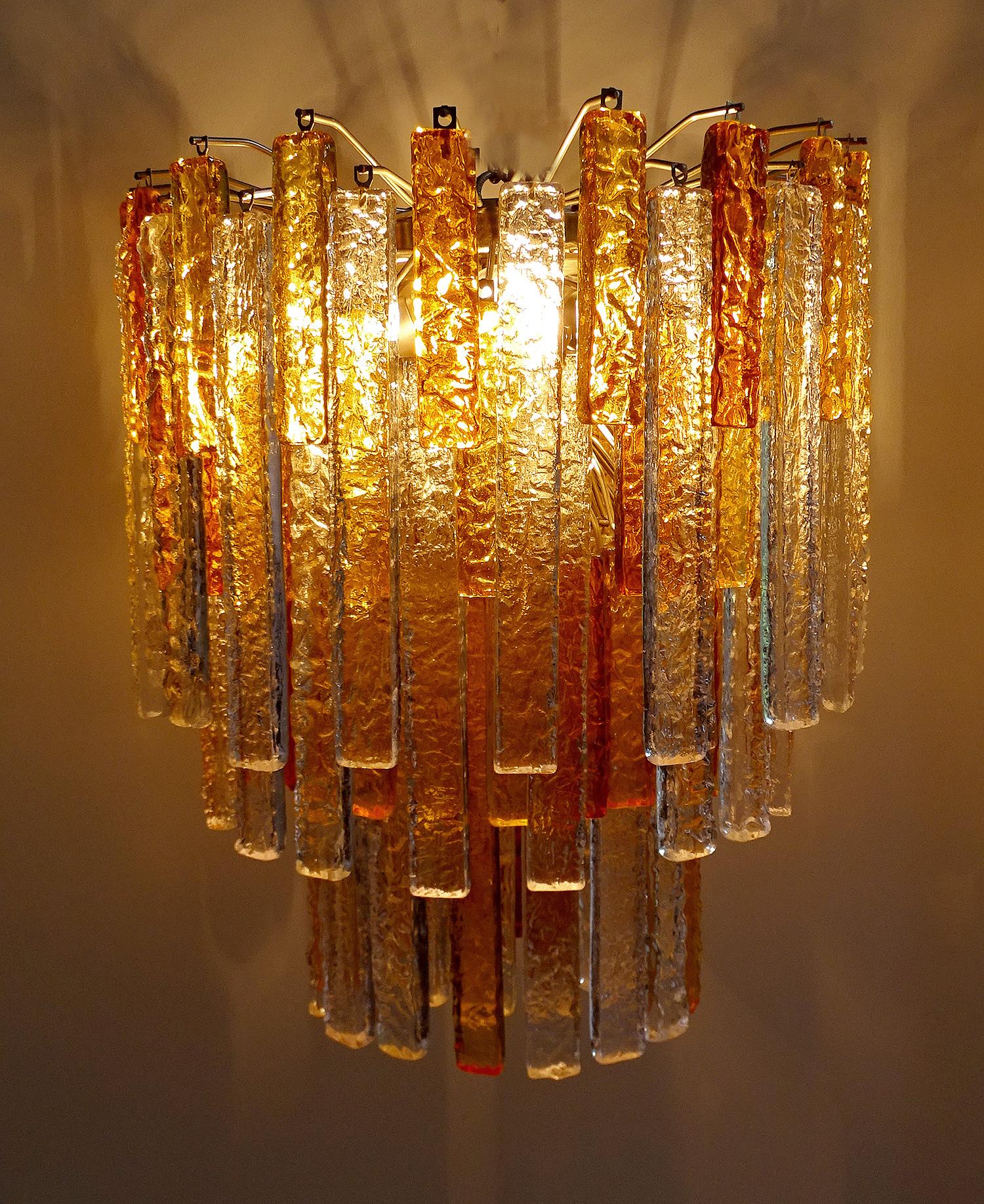 Pair of 1960s Murano glass chandelier by Mazzega, with each 127 textured pendants in five distinct colors and two height sizes: white, light yellow, light amber, amber and dark amber tone. The number of colors pendant differs somewhat for both