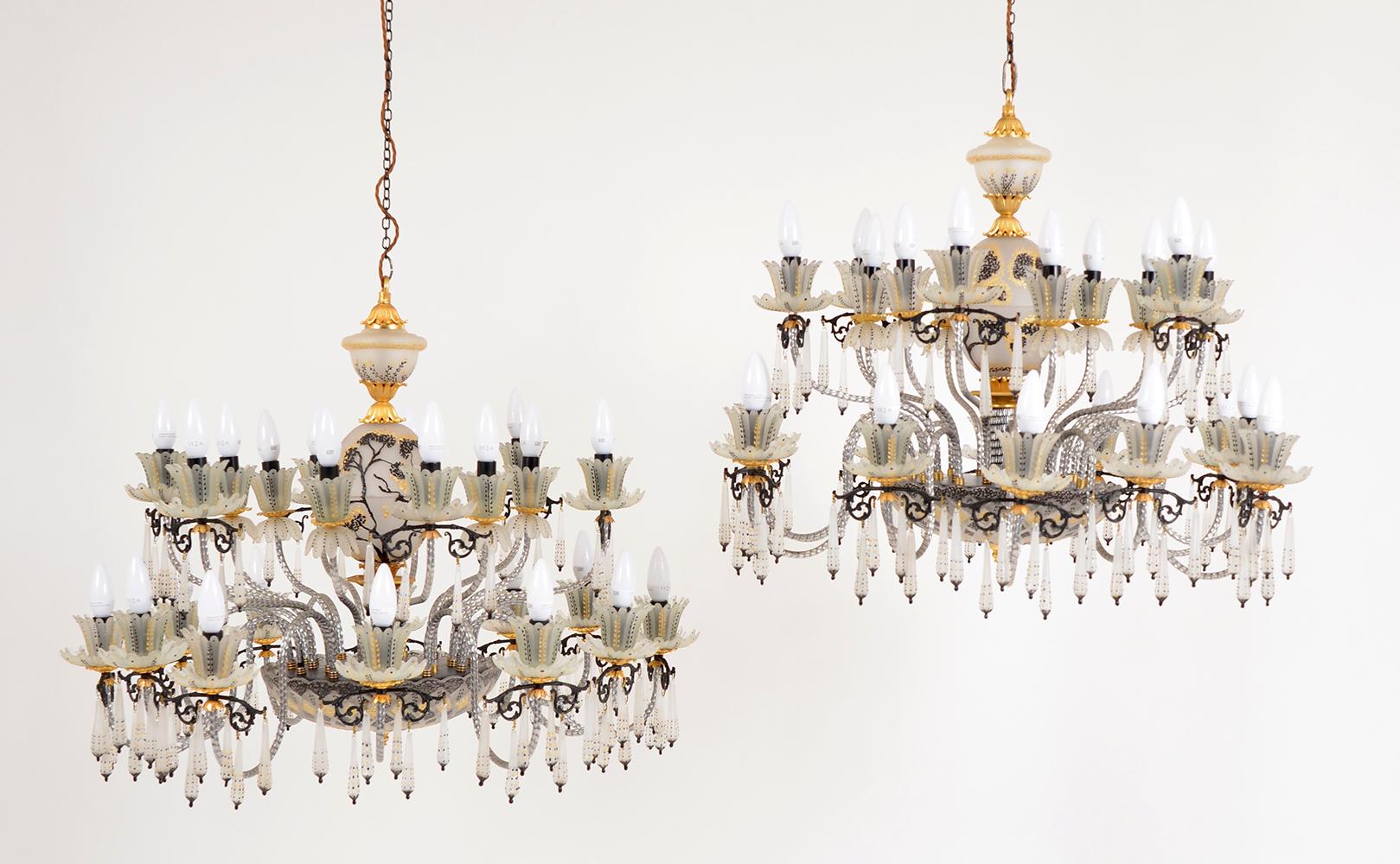 An outrageous pair of Venetian glass chandeliers of large proportions hand painted with gold and black decoration. A fantastic opportunity to buy a pair of flamboyant chandeliers, bought from a grand hotel foyer on the south coast of England.