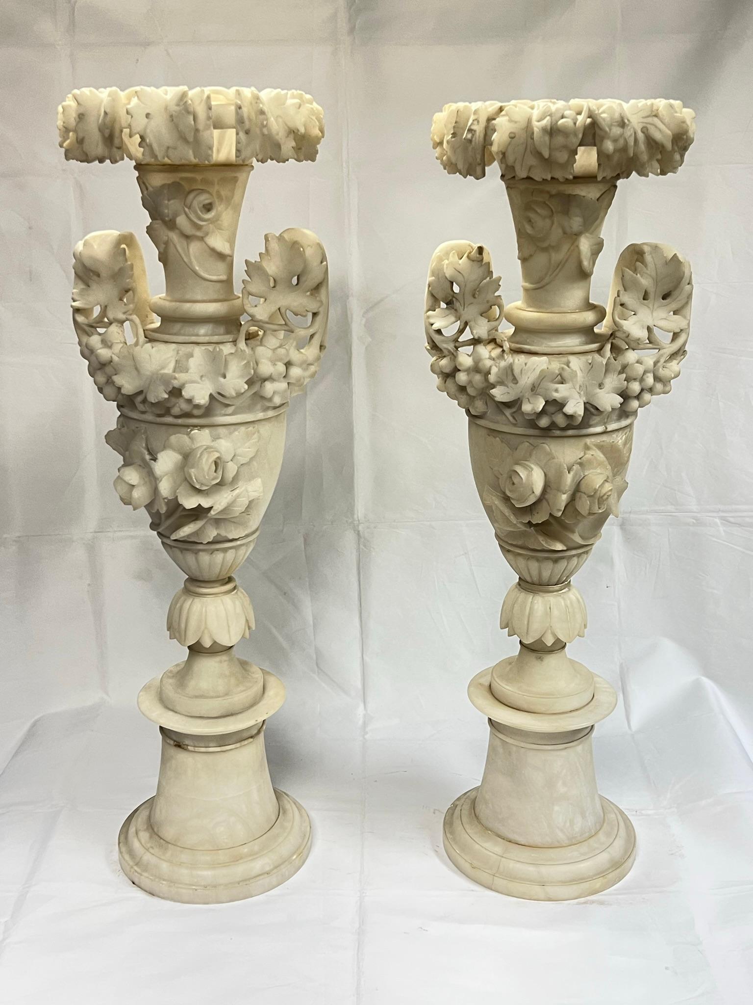 Pair of very large and very finley hand carved 19 century Italian alabaster  vases with roses and floral swags carved in high relief.  Previously drilled for use as table lamps.  