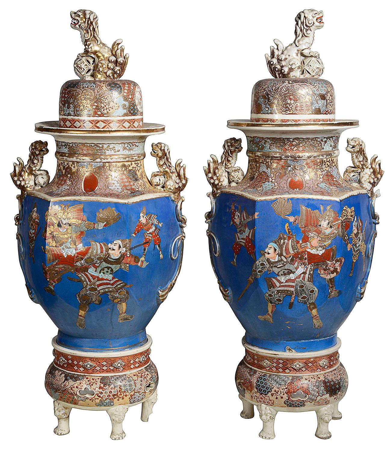 A very impressive pair of Japanese Meiji period (1868-1912) Satsuma lidded Koros (Vases) Each with a bold turquoise ground, classical gilded decoration, three Dog of Foo to the lids and handles, scenes of fighting Samurai warriors.