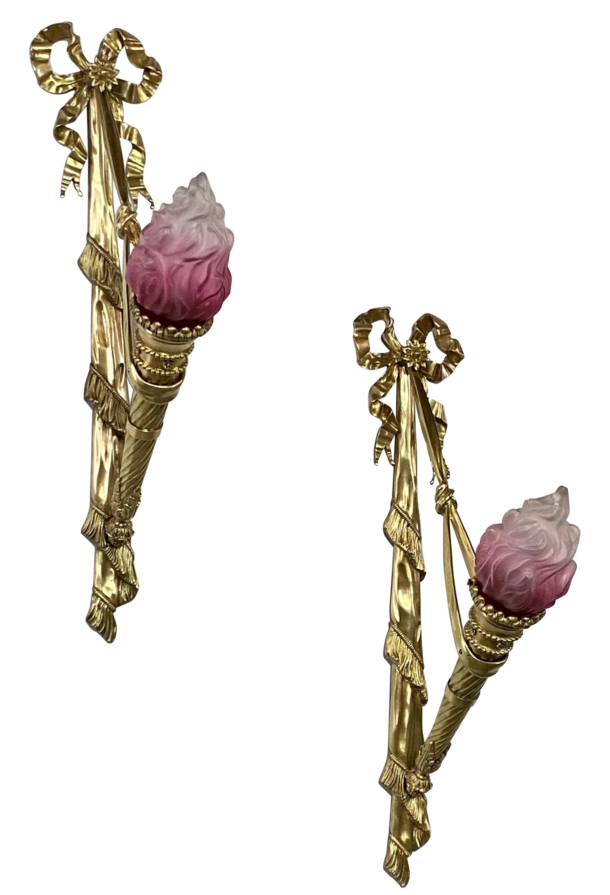 A large pair of Beaux Arts period solid brass torch style wall sconces with original frosted and cranberry color flame glass shades.
France, circa 1900, early 20th century.
Recently refurbished and rewired. In excellent antique condition.
For