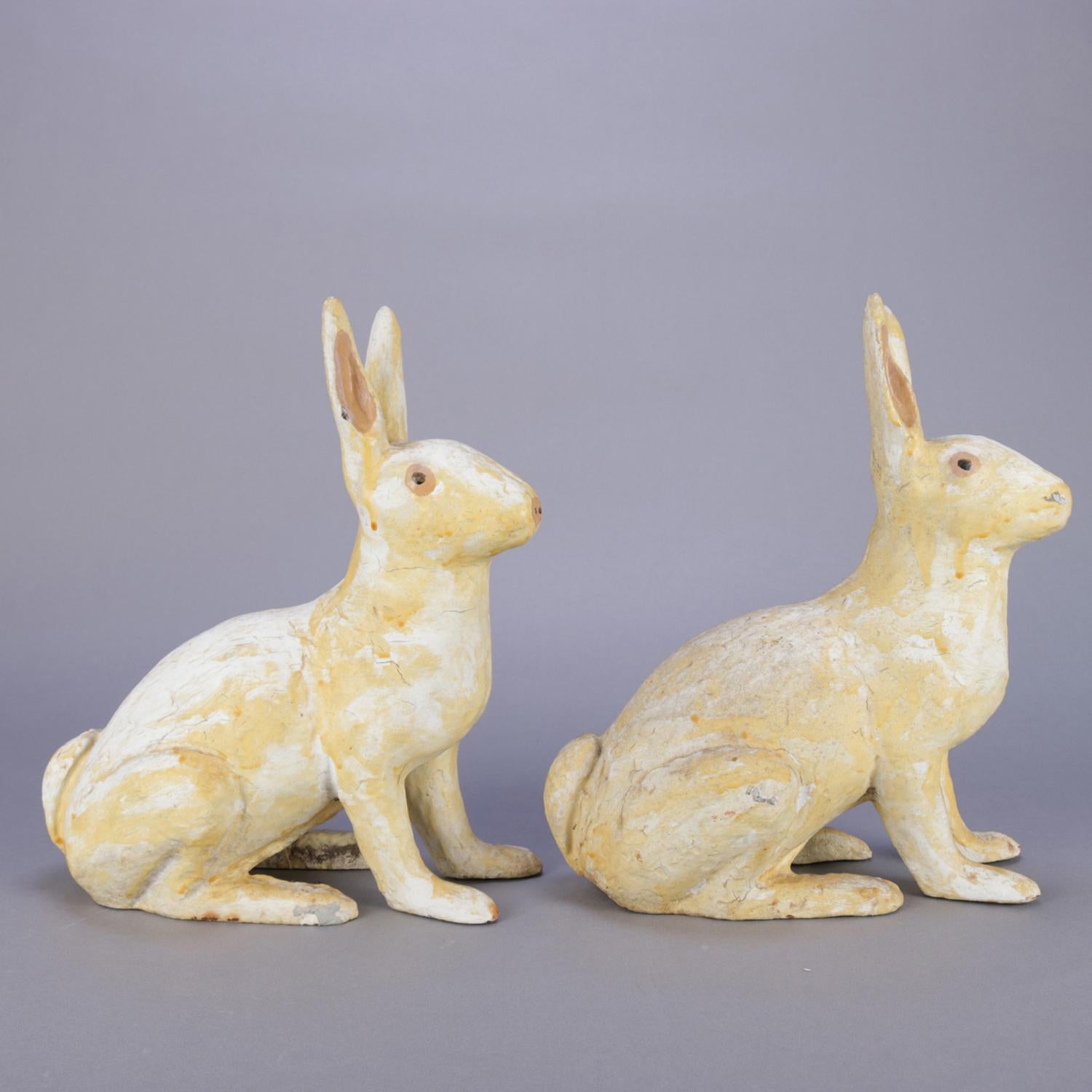A pair of large and antique figural doorstops feature painted sculptural cast iron seated white rabbits, reminiscent of Easter bunnies (bunny), circa 1890.

Measures: 12