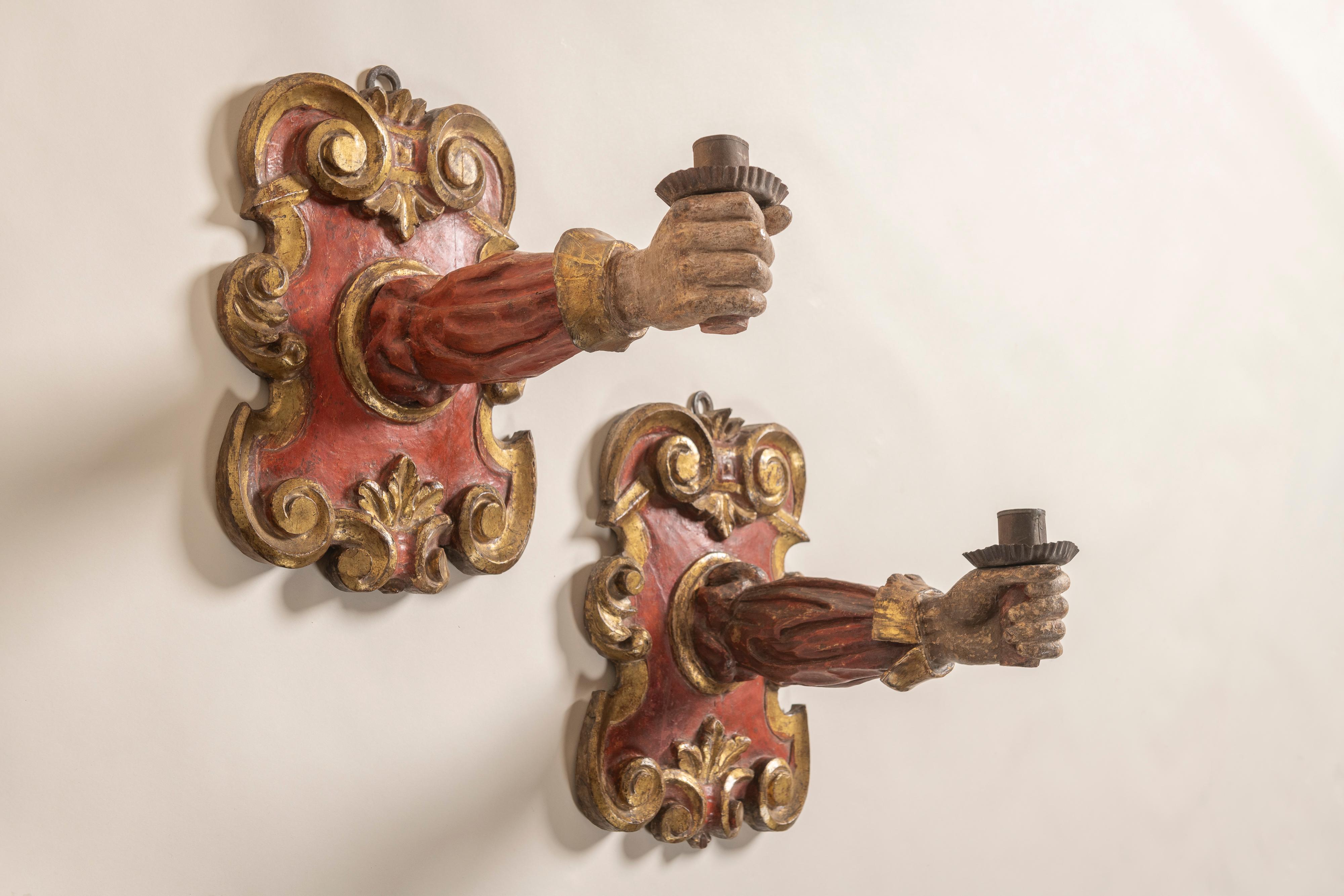 Impressive pair of Italian Baroque Painted and Parcel Gilt Applique Candle Sconces. Each sconce of rectangular cartouche shape, enriched with carved foliate scrolling volutes centering oval reserves issuing a fully realized sleeved and cuffed arm,