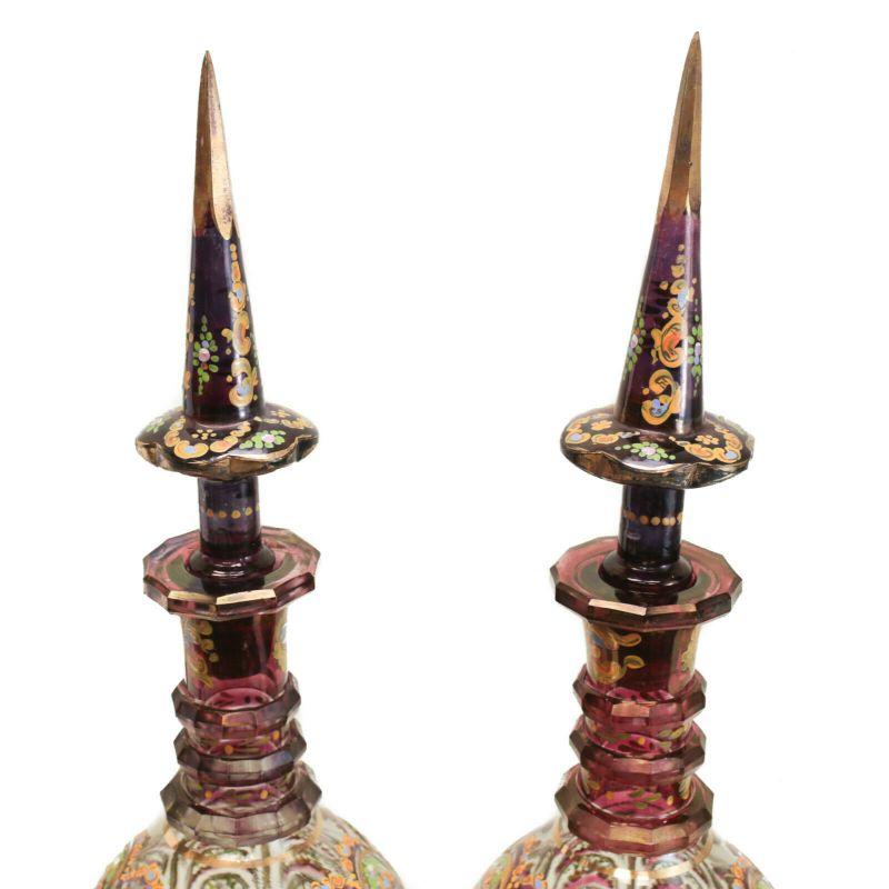 Pair large bohemian cranberry glass & enamel hand cut persian decanters, circa 1920.

A large and attractive pair of Bohemian cranberry red art glass hand cut decanters, dating to the 1st quarter of the 20th Century. Beautiful multi-colored enamel