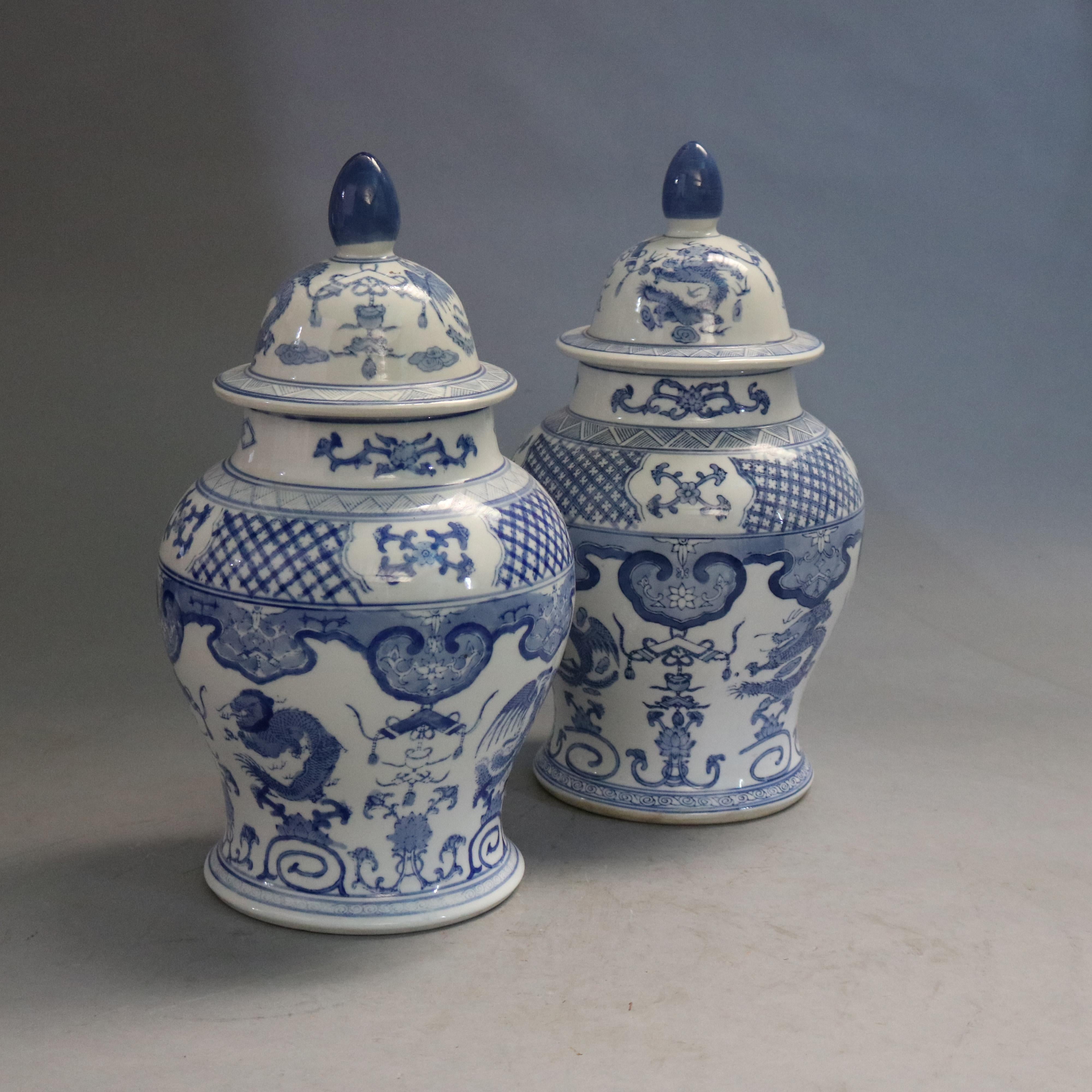 A matching par of oversized Chinese lidded urns offer porcelain construction with allover blue decoration including dragons and phoenix, stamped on base as photographed, 20th century

Measures - 17.75''h x 9.5''diam.

Catalogue Note: Ask about