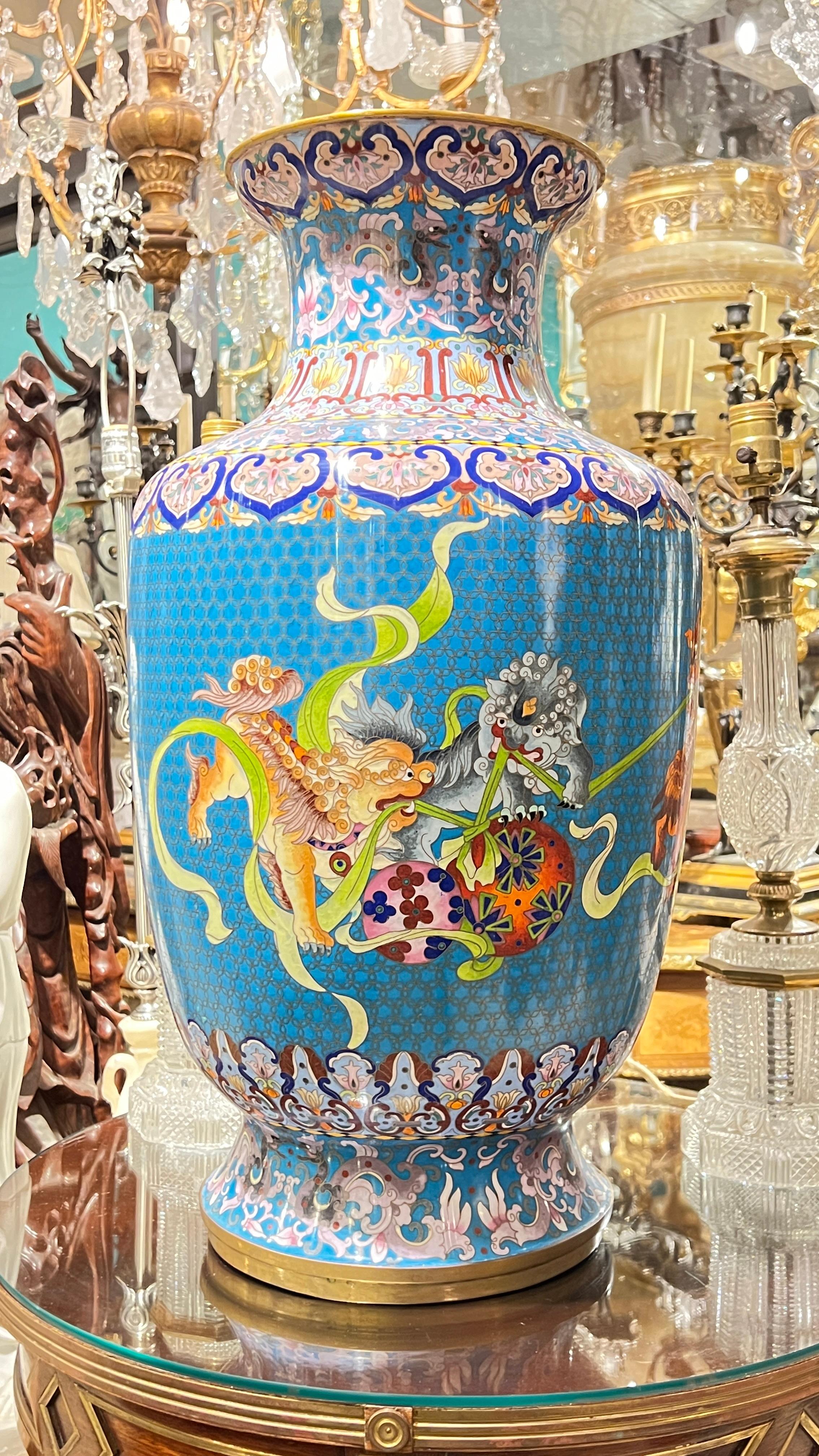 Pair of very impressive Chinese  vases, 25 1/2 inches tall, with the finely crafted figures of fu lions tugging at ribbons.  
