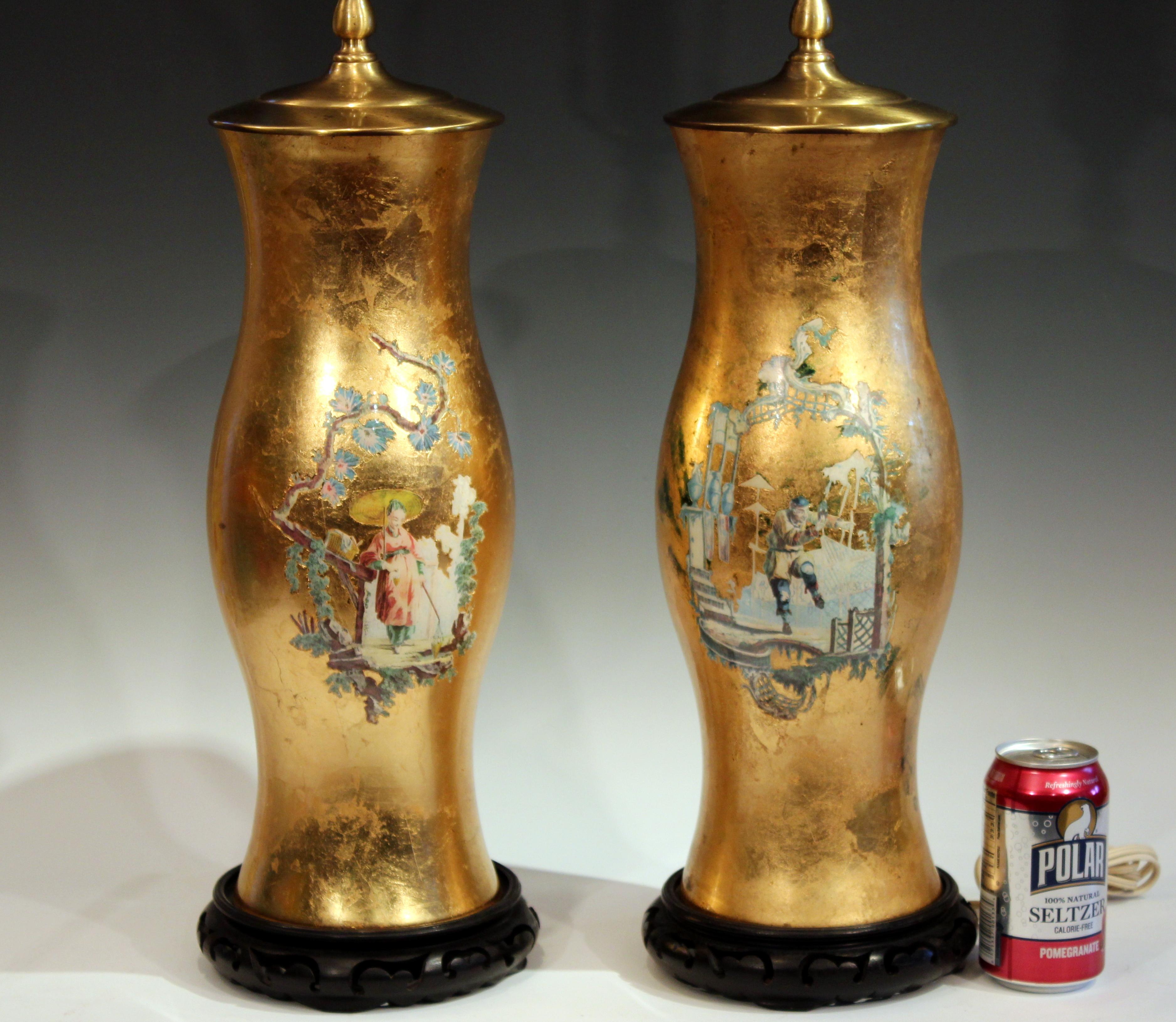 Vintage pair of églomisé decalcomania lamps with chinoiserie garden scenes and floral borders on a gold gilt ground, circa 1980s. Measures 36
