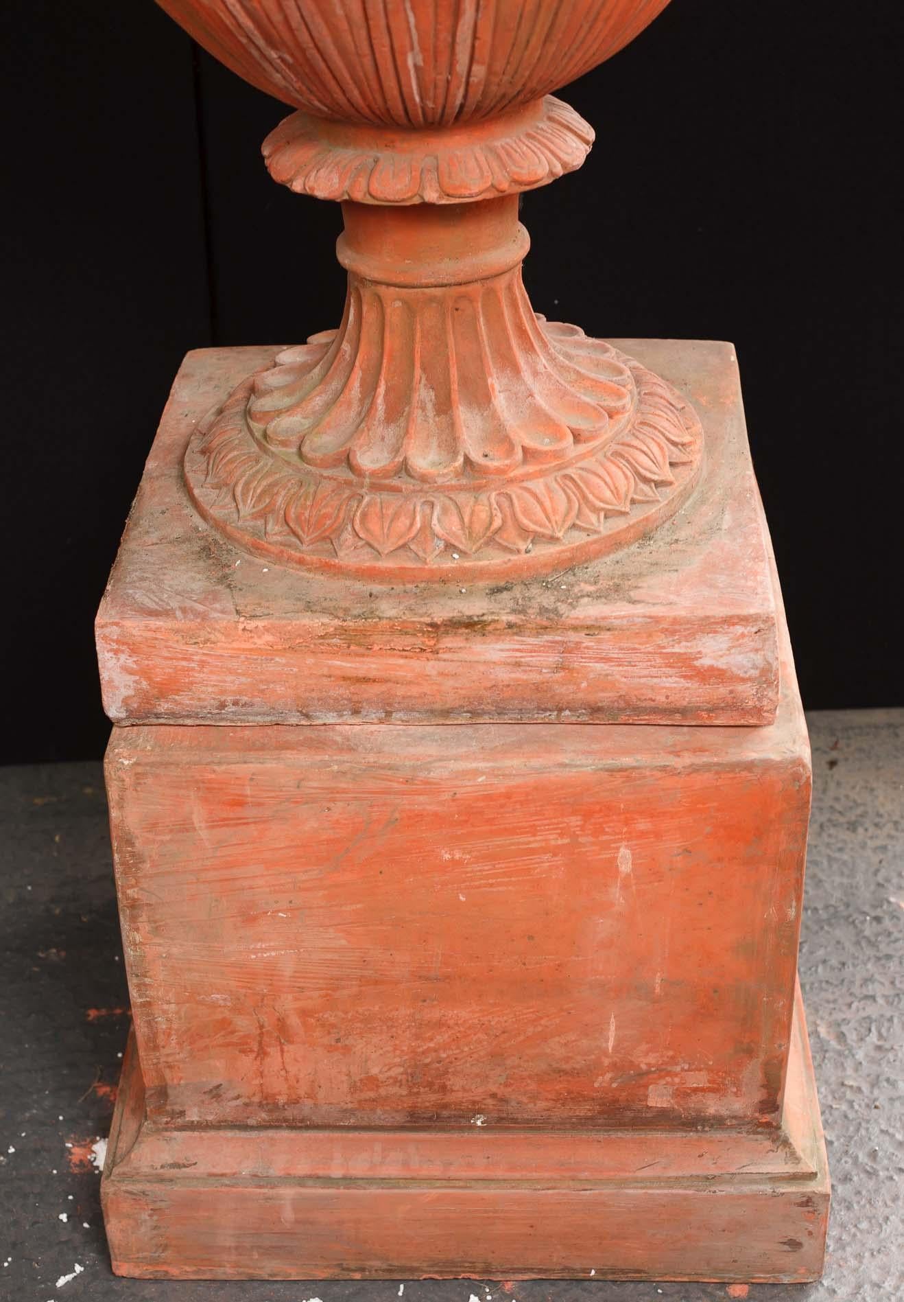 - Stunning pair of massive English terracotta garden urns
- If you are looking for that classic English garden look - then here it is
- Impressive pair of an important architectural quality
- Stand in at almost seven feet tall on the pedestal