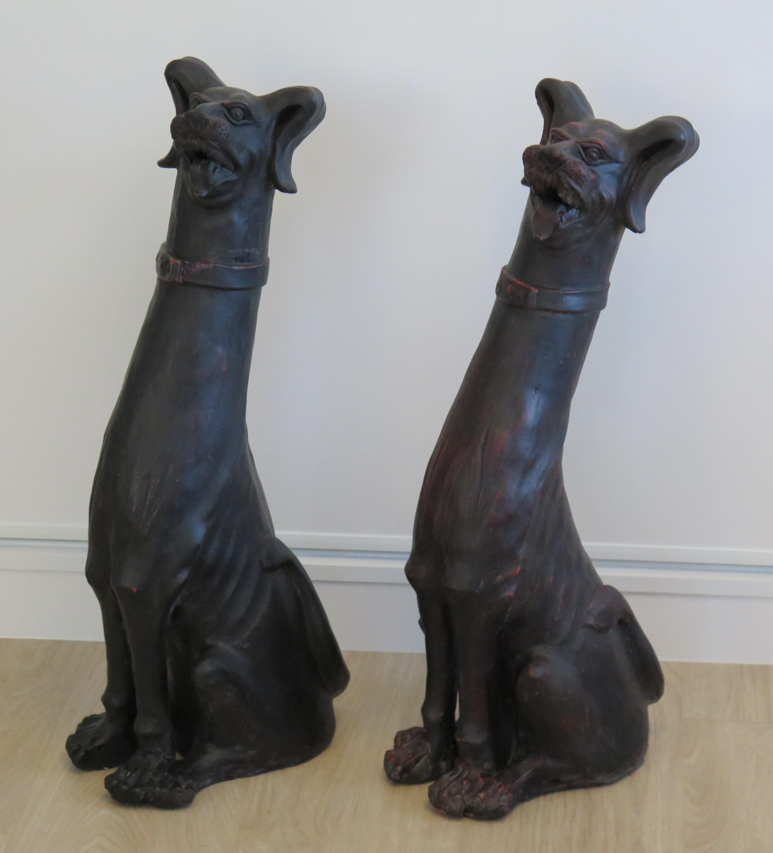 These are a large PAIR of antique earthenware (or terracotta) pottery Grotesque Dog sculptures, all hand made and dating to the 19th Century, probably made in Italy.

These life-size sculptures ( nearly 27 inches high) are quite different, being