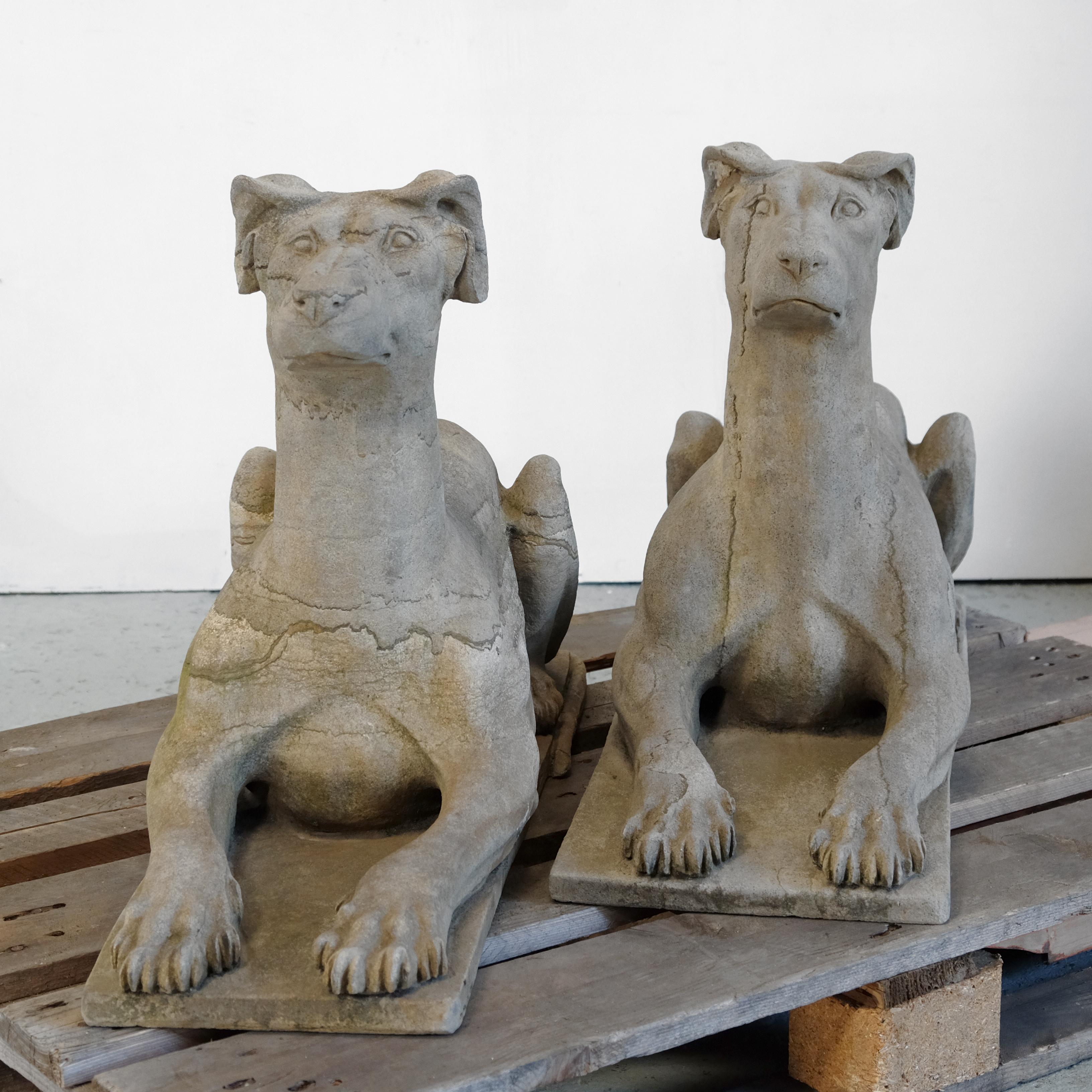 A magnificent pair of hand carved solid stone dog statues which I believe to be in sandstone with its grainy texture and wonderful veining throughout. Strong and muscular in appearance, they would look very impressive sitting guard either side of a