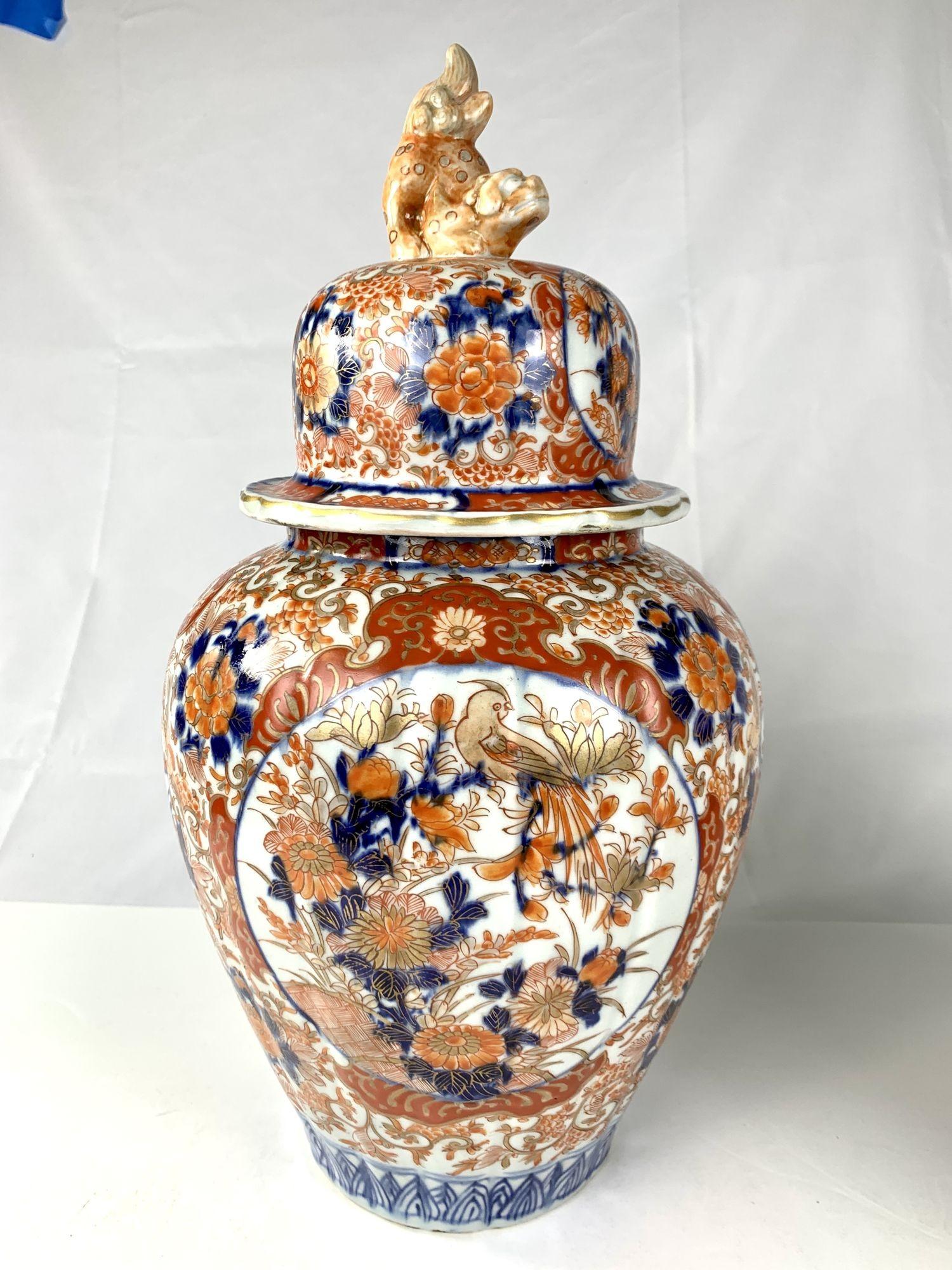 This pair of hand-painted, antique Japanese Imari porcelain jars dates to the late 19th century, circa 1880.
The jars are decorated with a traditional Japanese Imari motif of birds and flowers painted in enamels of intense iron red, deep cobalt