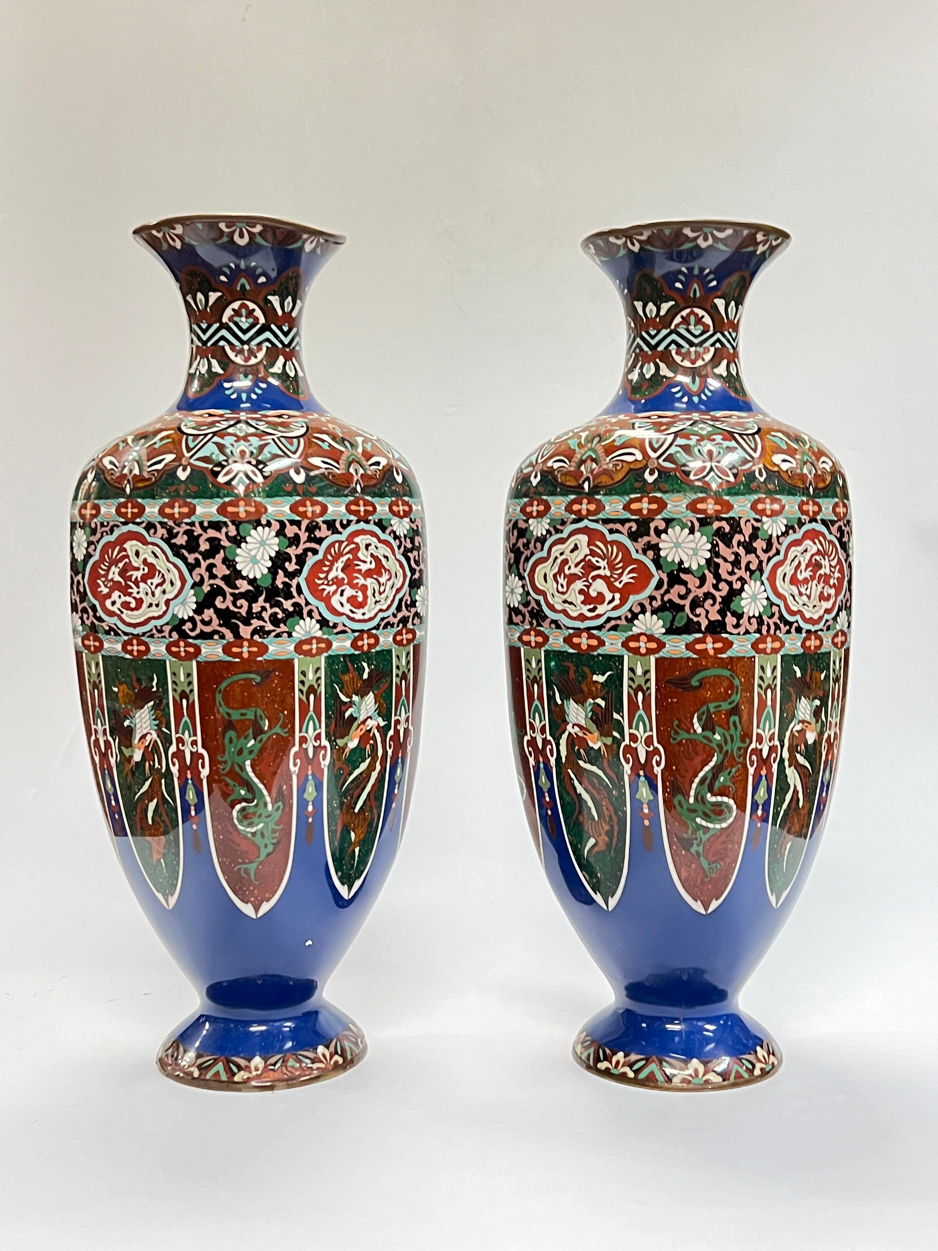 Pair of brilliant blue Japanese Meiji period cloisonne enamel metal vases with rounded square shape.  Each 24 by 8 1/2 by 10 inches.