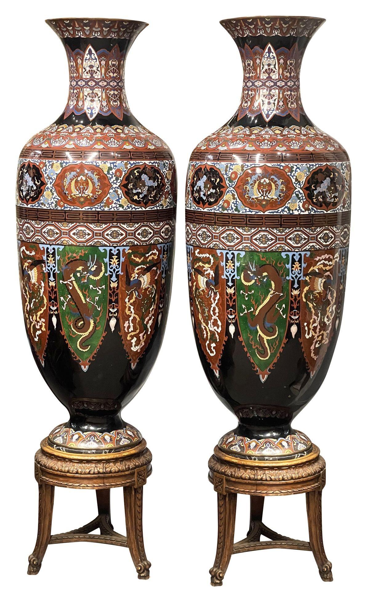 Vasi in smalto cloisonné giapponesi del periodo Meiji (1868-1912) di grande effetto e di ottima qualità su supporti in legno intagliato. Ognuno di essi presenta una meravigliosa decorazione a motivi classici sui bordi, con scene di draghi e creature