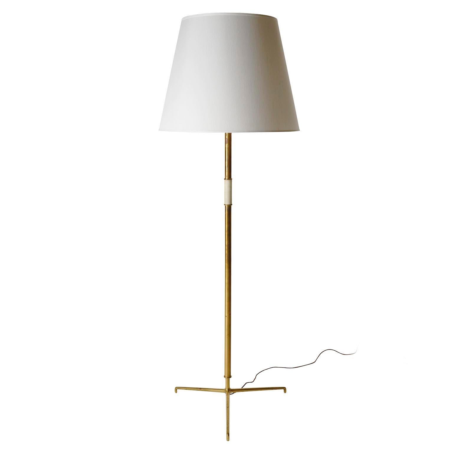 A pair of large brass floor lamps model 'Helios' no. 2035 manufactured by J.T. Kalmar in Mid-Century, circa 1960. 
The lamp is documented in the Kalmar catalogue from the 1950s as well as in the catalogue from the 1960s. It was the most expensive