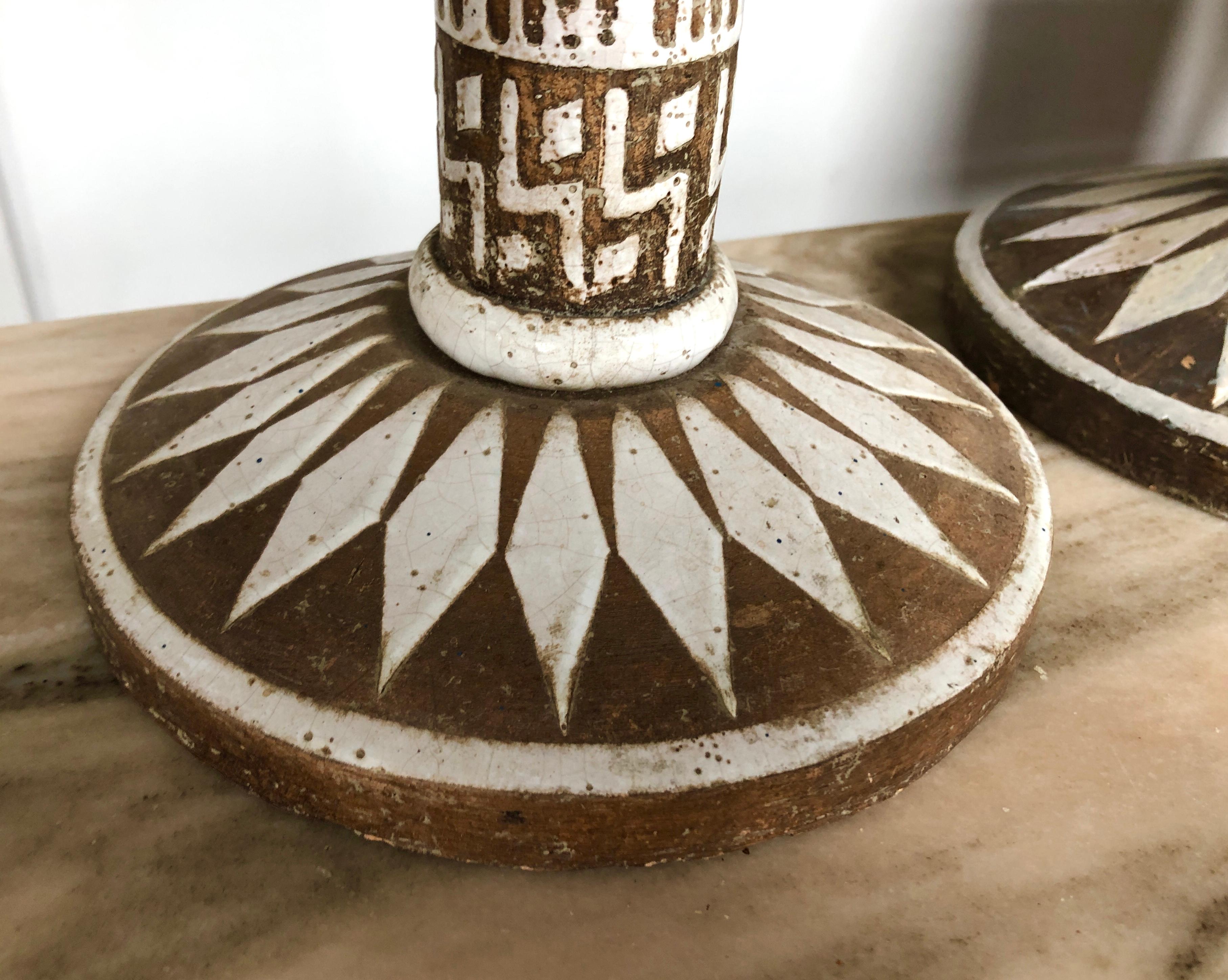 Hand-decorated, white glaze on brown pottery, employing abstract geometric patterns, signed to underside with artist cipher and “For B. Altman & Co.”, circa 1950s.

Ceramic base is 21