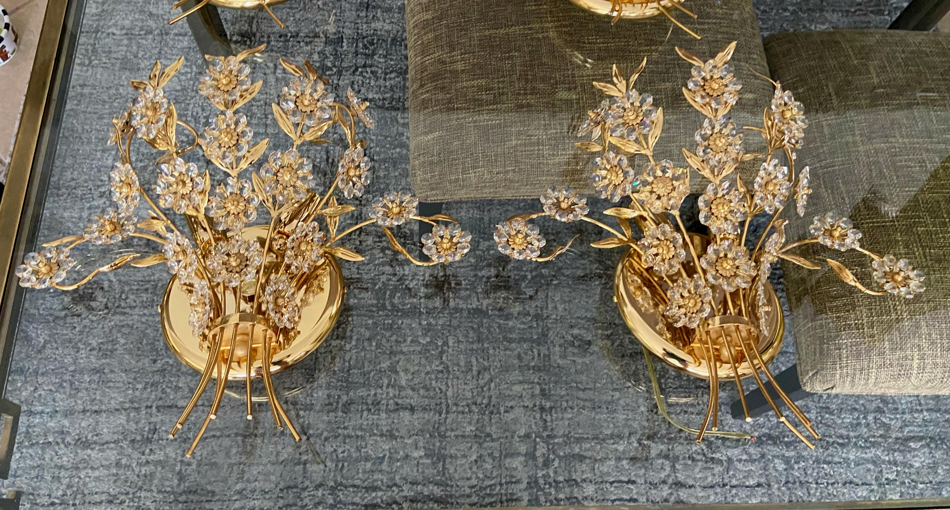 Pair of large scale crystal and gold-plated metal floral motif 2 light wall sconces attributed to Palwa, Germany. Each sconces uses two candelabra base bulb. Newly wired. Second pair available under separate listing.