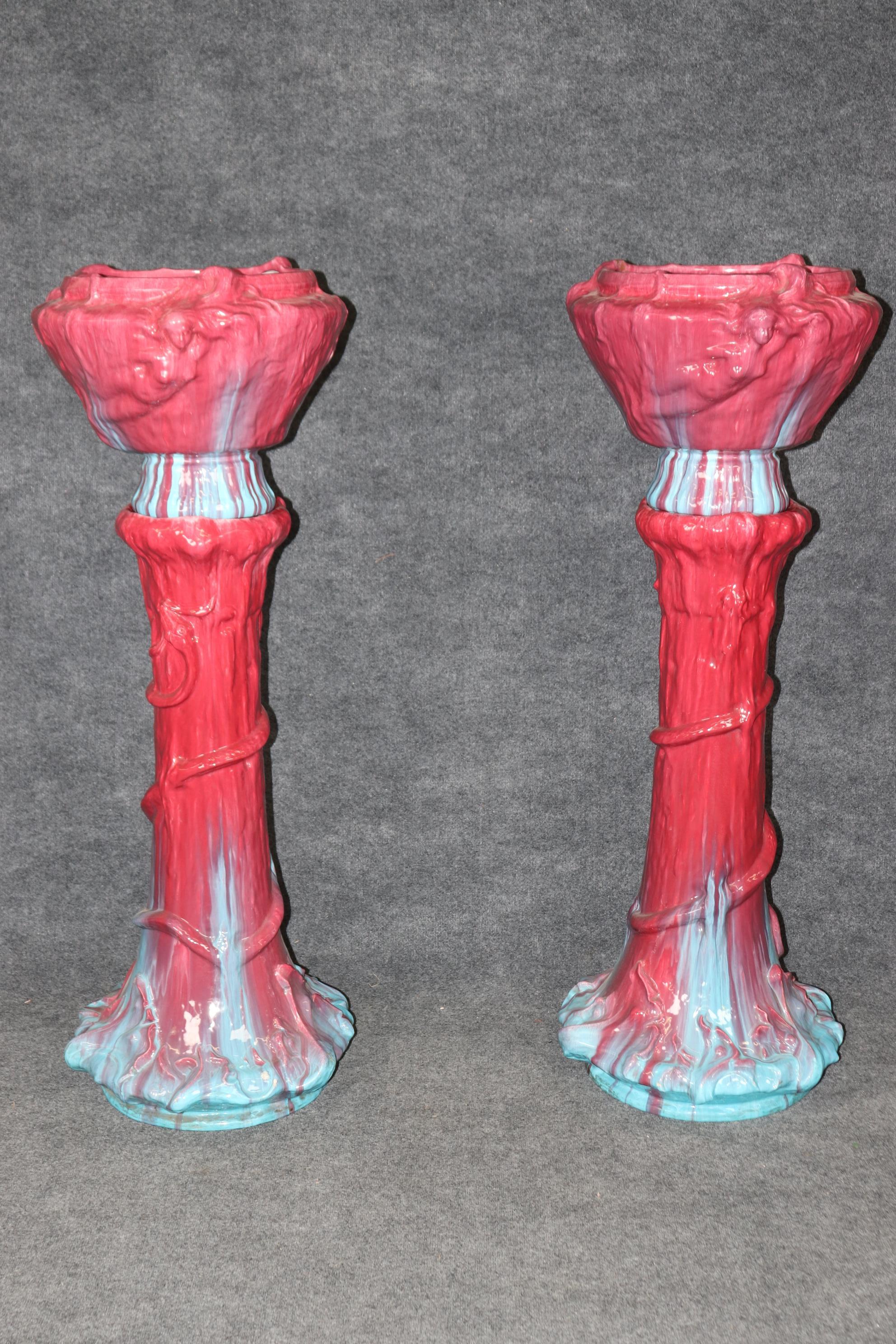 Il s'agit d'une paire monumentale de jardinières en majolique incroyablement vives et lumineuses. Elles sont recouvertes d'une glaçure rose rougeâtre à bleue qui fera un effet fantastique ou un point focal dans votre couloir ou votre entrée. Ils