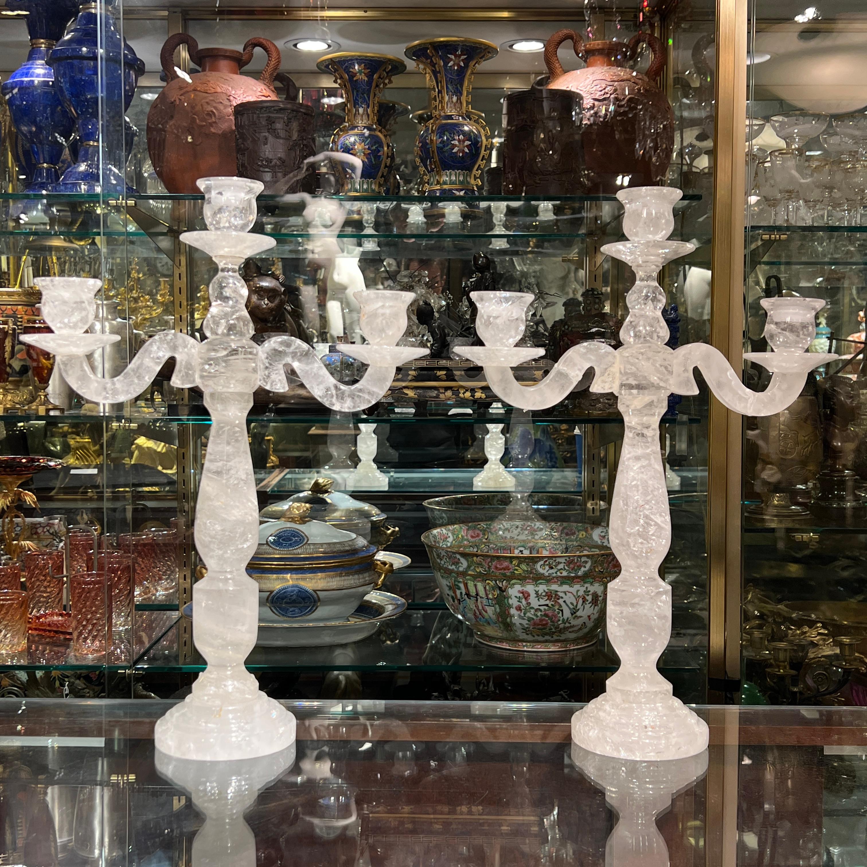 Pair of vintage three-light candelabra candle holders finely cut from rock crystal, measuring 19 1/4 by 13 1/4 by 4 1/2 inches.