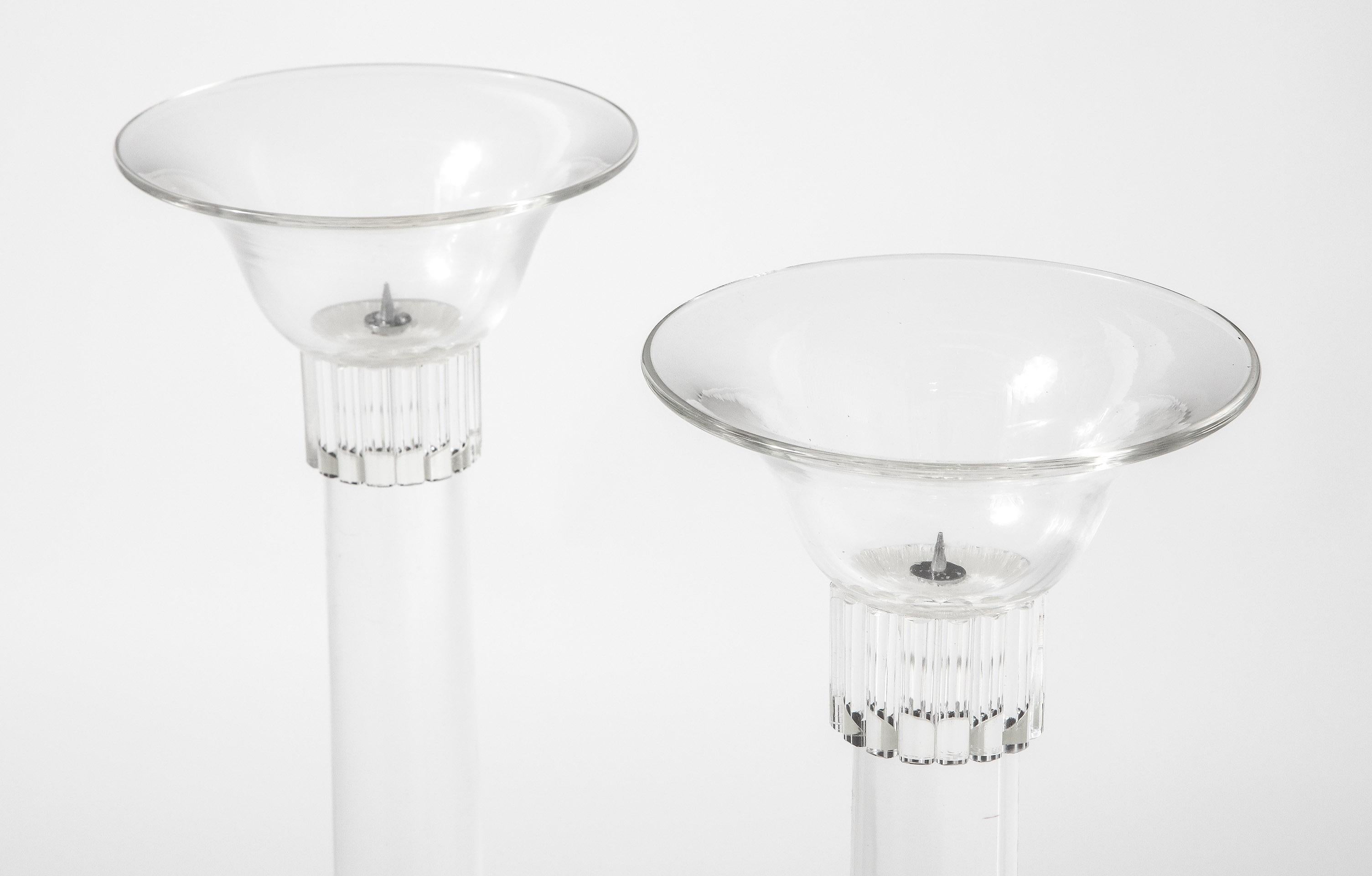 A pair monumental candlesticks with concave base and a convex top, the central stem having fluted capitals top and bottom.