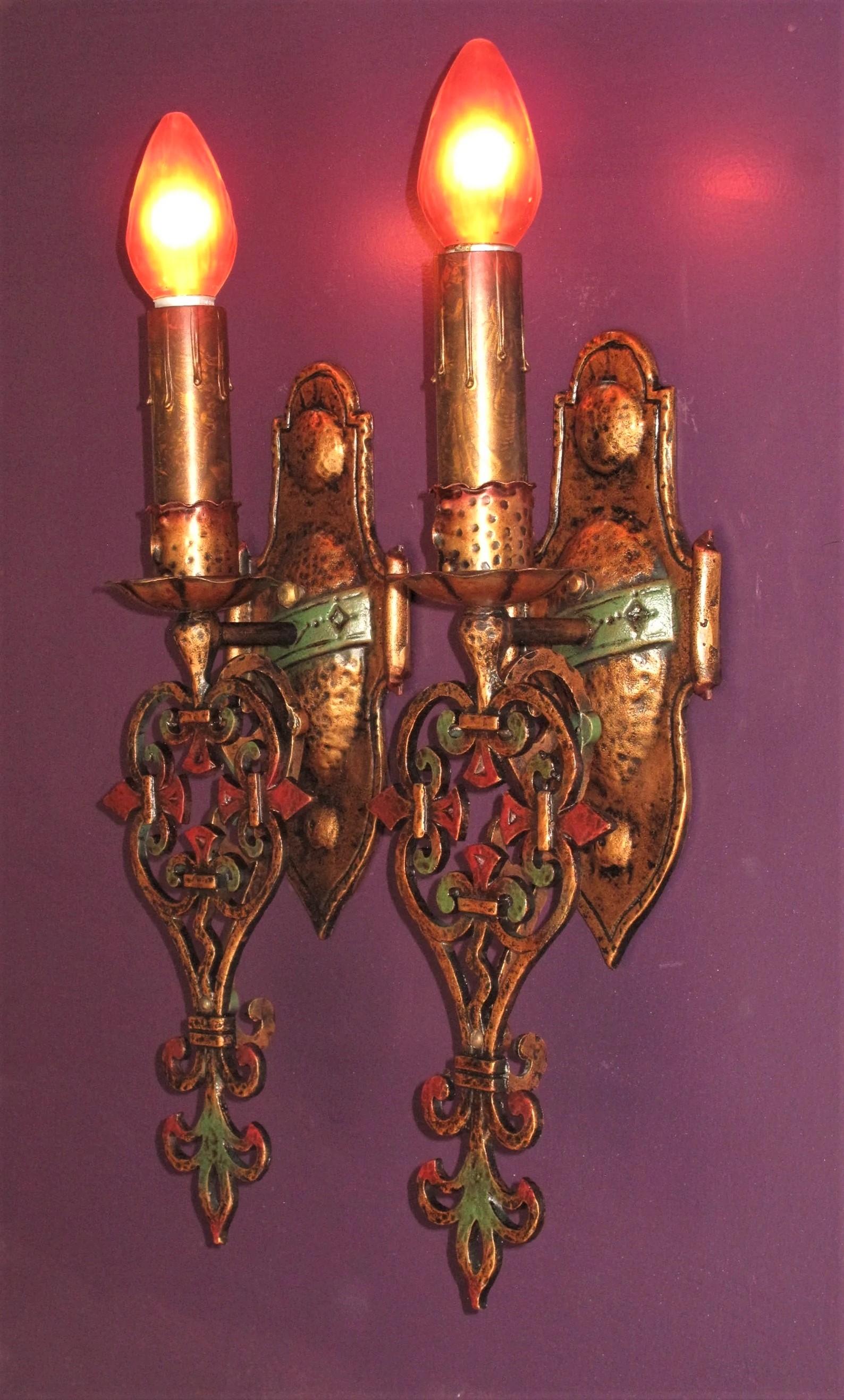 3 pair available, priced per pair.  Single at 1/2 pair price.
Large and impressive 1920s Spanish Revival sconces painstakingly restored to exactly match original finish by our in house artisan. Note the red accent on the top of the candle sleeves,
