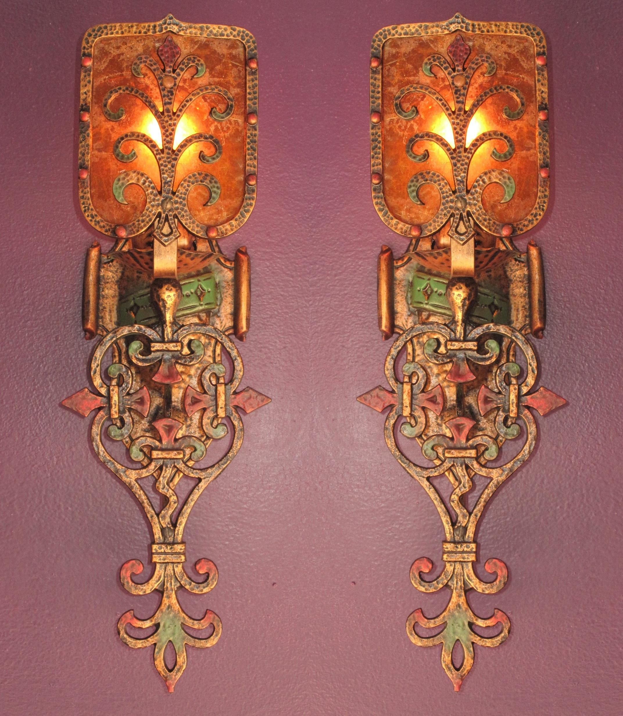 Pair of large and impressive 1920s Spanish Revival sconces with their original mica shade.
They have been painstakingly restored to exactly match original finish and color by our in house artisan. Attributed to the Feldman Co., an LA based lighting