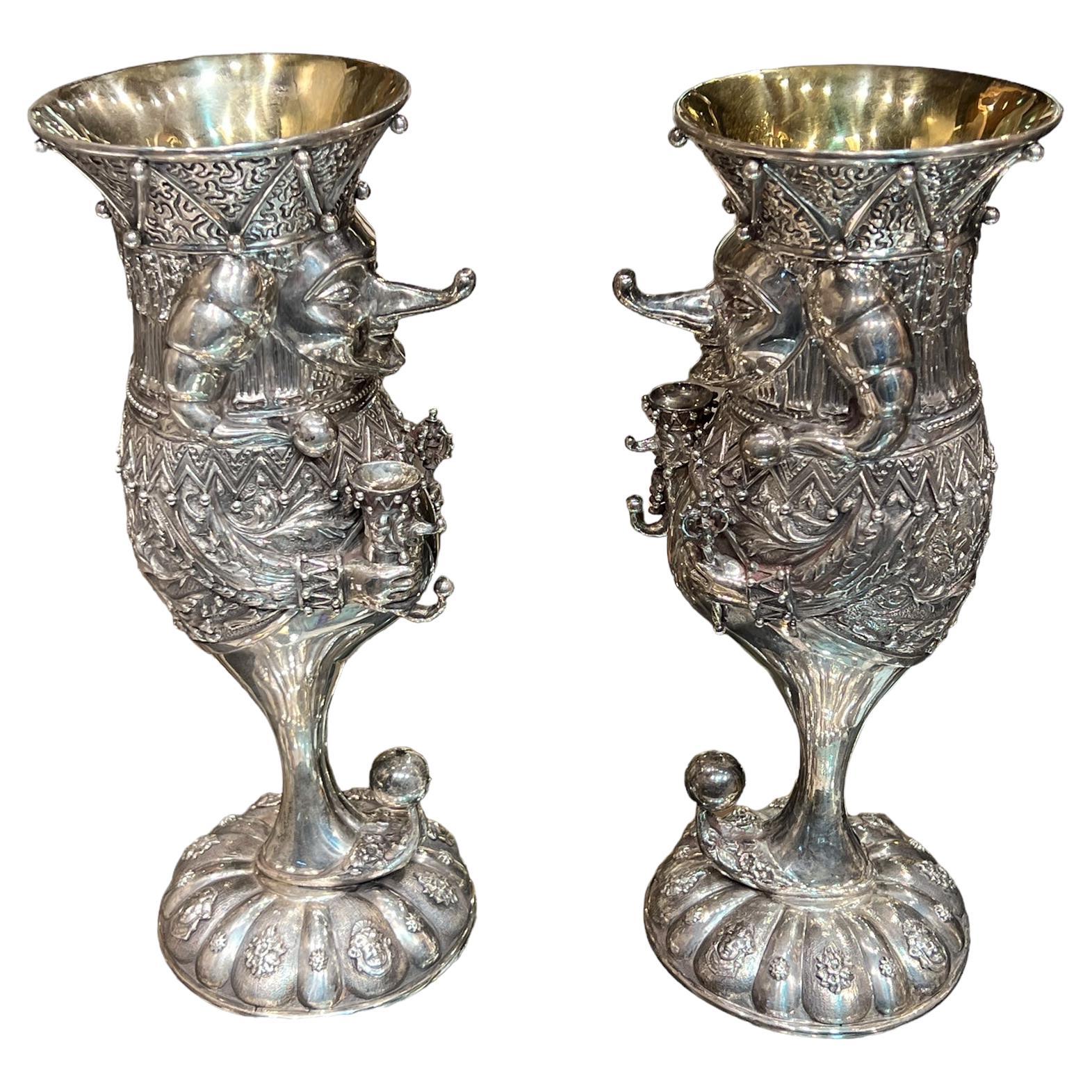 Our sterling silver goblets in the form of the clown, Petrushka, by the Russian artist, Mihail Chemiakin (1943- ) each measure 10 1/2 in (26.7 cm) by 4 in (10.1 cm) and are in excellent condition, polished with tarnish in crevices.  Each signed on