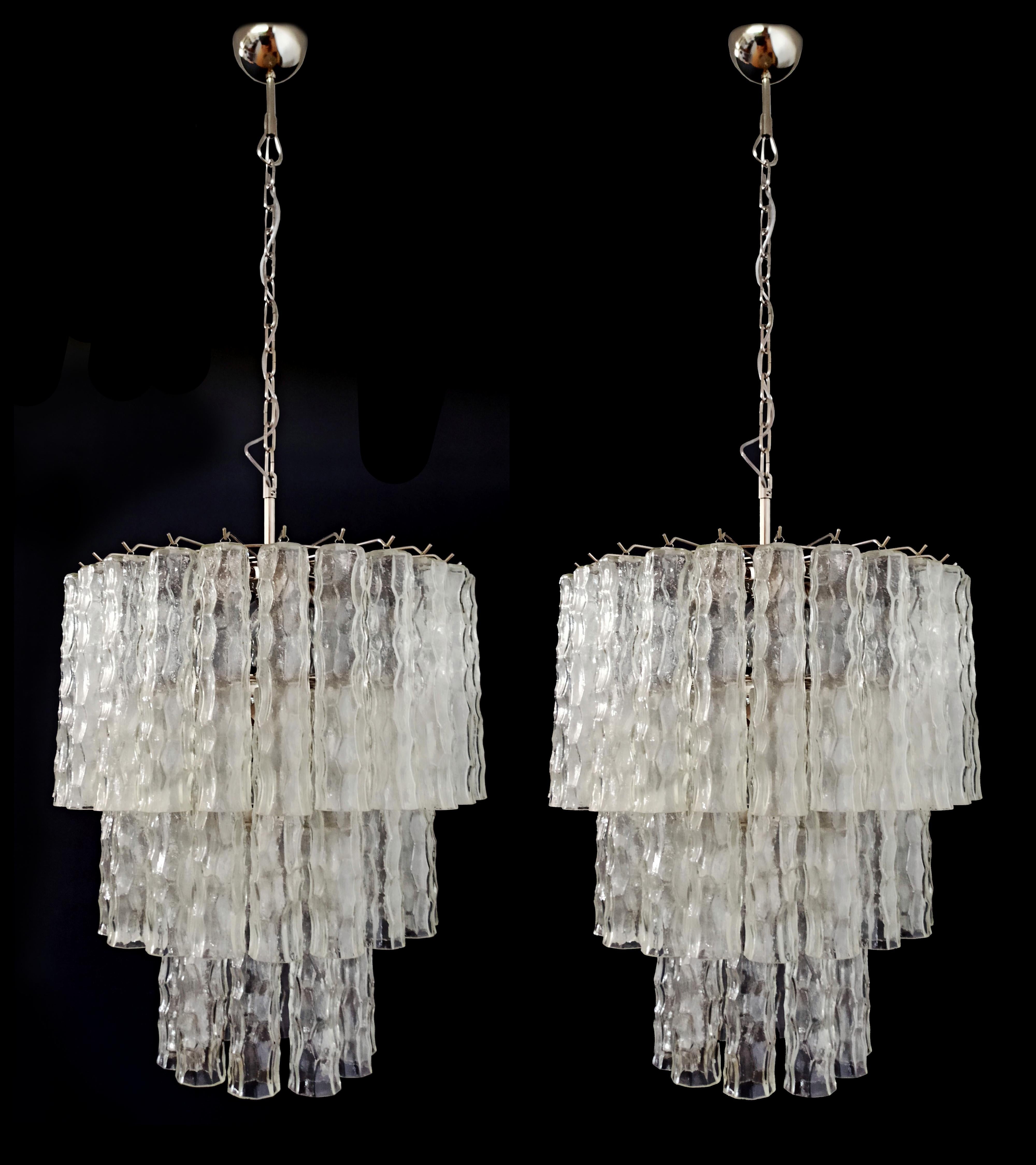 Pair of vintage Italian Murano glass chandeliers and nickel-plated metal structure. The shiny nickel armor supports 52 large clear glass tubes that have a slightly hammered effect to create an impressive 