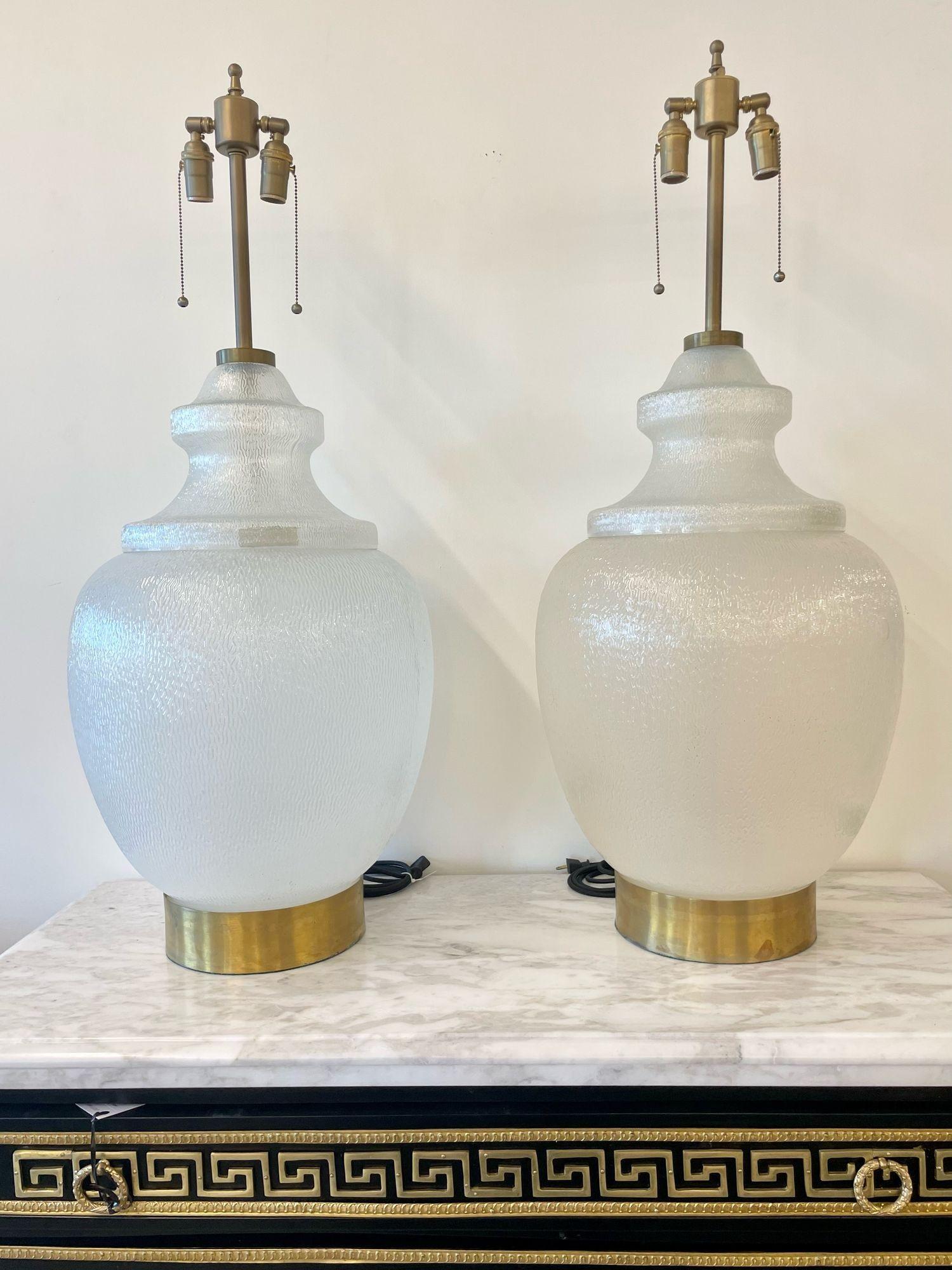 Pair Large White Mid-Century Modern Table Lamps, Textured Art Glass, Brass 1960s
 
Each having an artist branded stamp on the glass. The pair sold without shades. 
 
United States, 1960s
 
41.5 H x 16 D.
2 x e26 standard sockets
Shades not