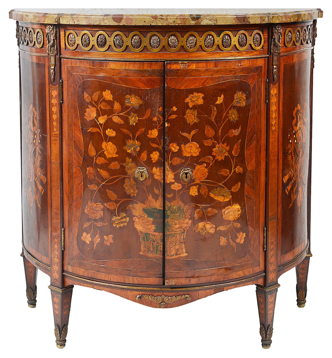A good quality pair of late 18th century marble topped, marquetry inlaid side cabinets, each with their original marble tops, scrolling ormolu mounts to the frieze, wonderful floral marquetry to the central doors, inlaid musical instruments with