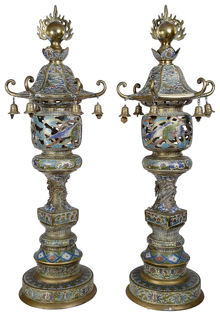 A good quality pair of Japanese bronze and enamel pagoda shaped garden lanterns. Each with a patinated bright bronze finish and multicolored classical enamel decoration, circa 1900.