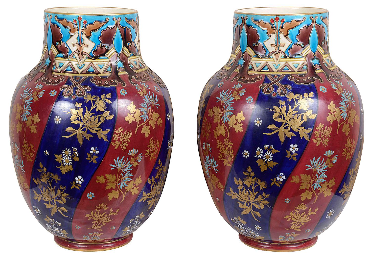 A very decorative pair of late 19th century Majolica hand painted vases / lamps. Each having turquoise, cobalt blue and burgundy ground, motif decoration to the necks, foliate and flowers decoration below.
The vases can be converted to lamps within