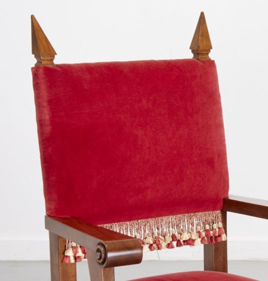 Late 20th c., a custom made pair of Italian armchairs designed in a modern take on Baroque style. The red velvet padded back and seat add a wonderful punch of happy color. The seat and back are trimmed in a silk passementerie in red and gold. The