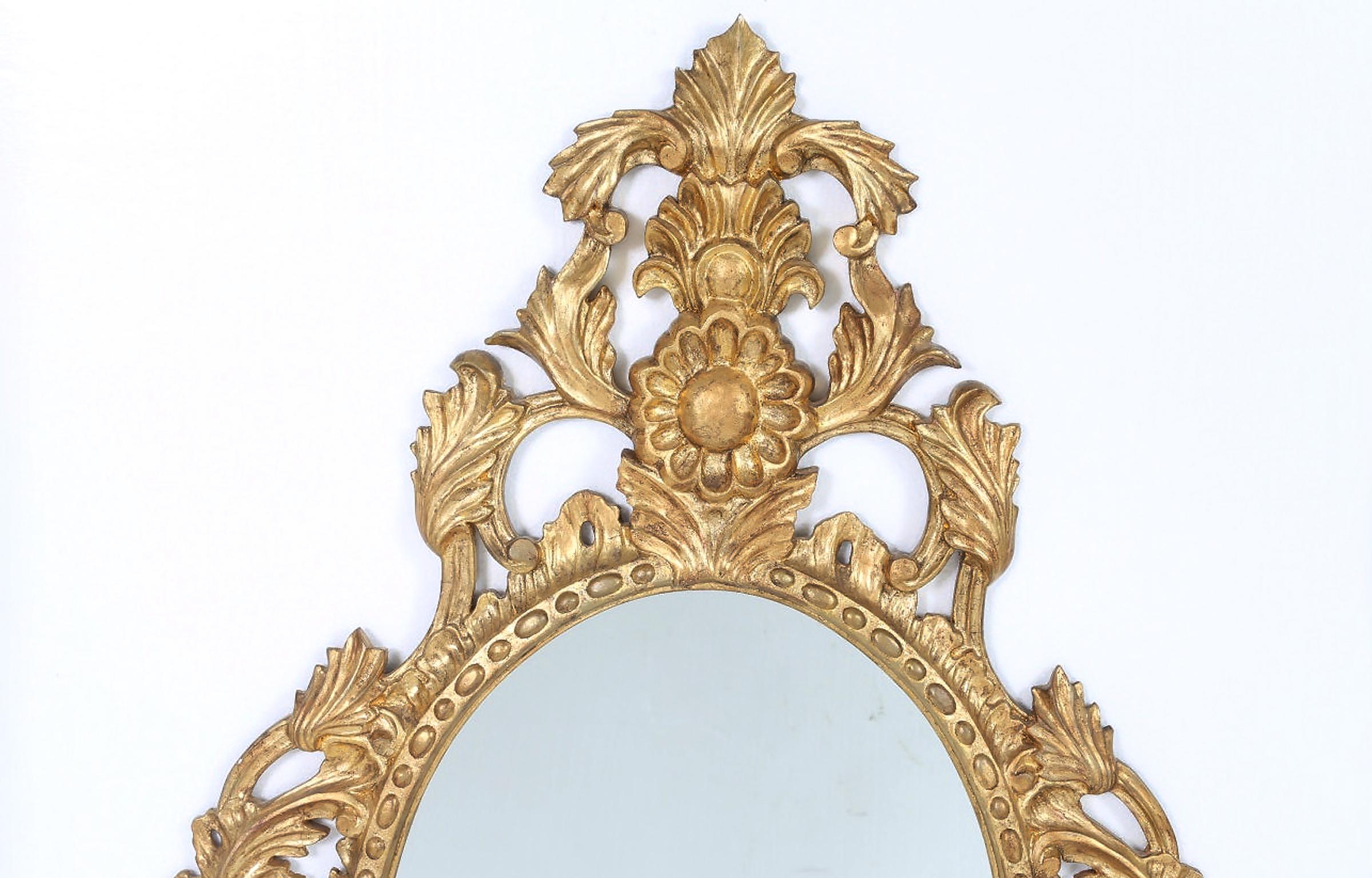 Pair of late 20th century giltwood frame hanging wall mirror. Each mirror is in good vintage condition with appropriate wear consistent with age / use. Each mirror measure about 44 inches high x 26 inches wide.