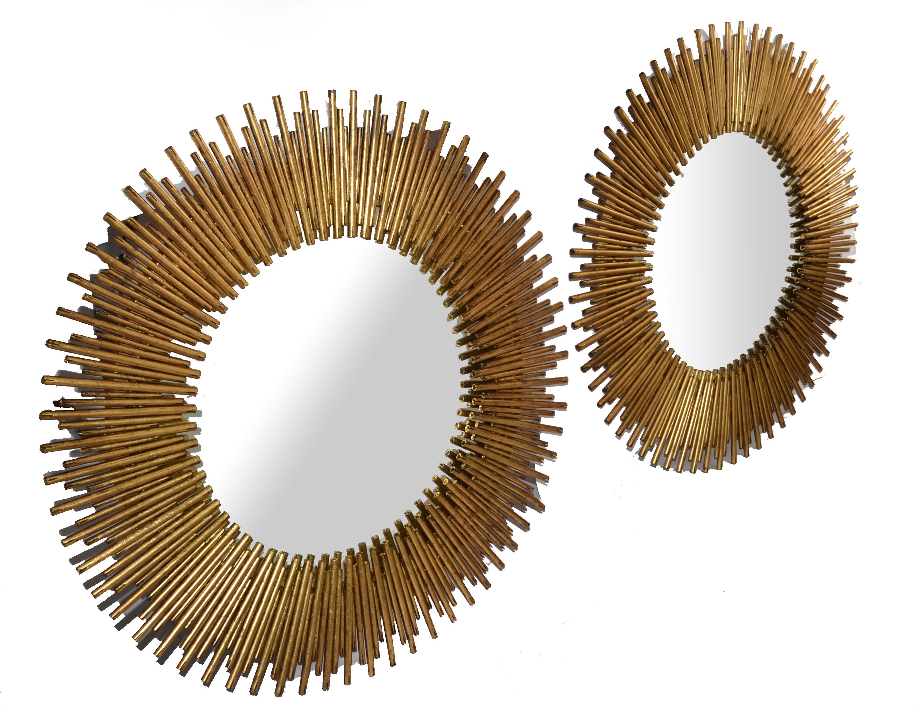 Pair of heavy Brass round Sunburst Wall Mirrors Mid-Century Modern in the Style of Chaty Vallauris, made in the late 20th Century.
Features brass metal tubes round frames with a large Mirror in the Center. This pair of eye-catching round mirrors