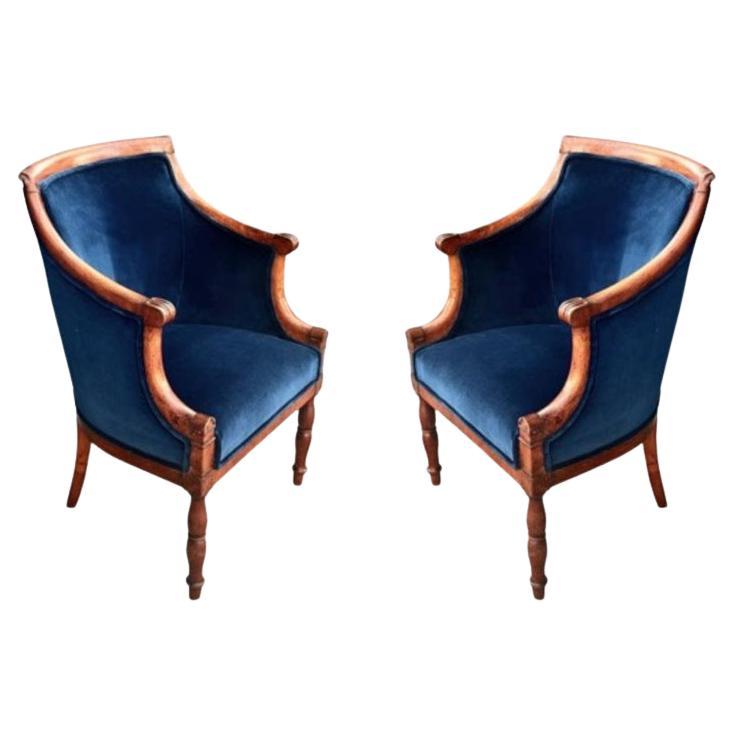This is a very  desirable pair of period Lat Empire Barrel Back Bergeres that date to c. 1810-1820. The chairs have retained their original surface which we have cleaned and applied several coats of hard paste wax. The chairs are newly upholstered
