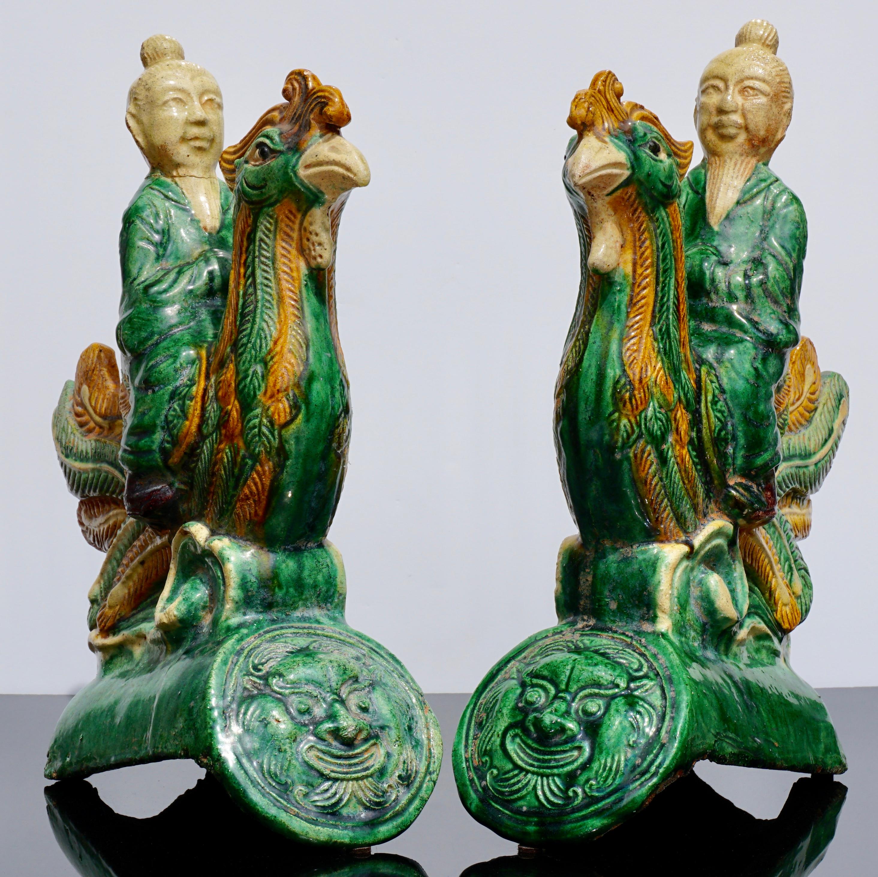 A beautiful and decorative pair of animated terracotta pottery roof tiles depicting Male figures riding roosters. The Sancai greens, yellows and cream pop with detail making these late Ming early Qing dynasty fantastic on your mantle, bookshelf or