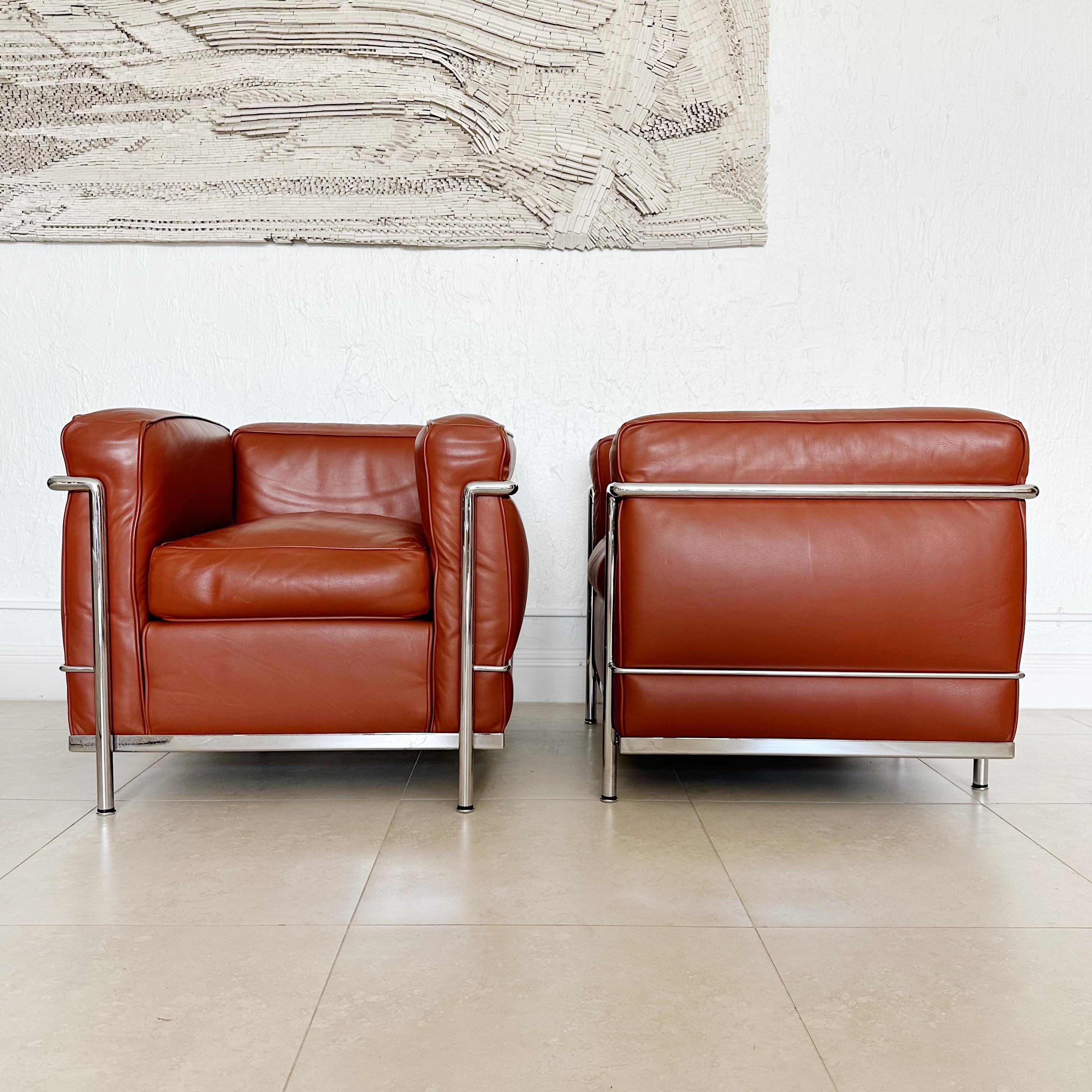 Pair of Classic design, modernist chairs, petite model, Le Corbusier by Cassina. Our pair has a cognac brown leather and chrome finish frame with Le Corbusier by Casino engraved in the frame by Cassina. Circa early 1980's. Price is for the pair,