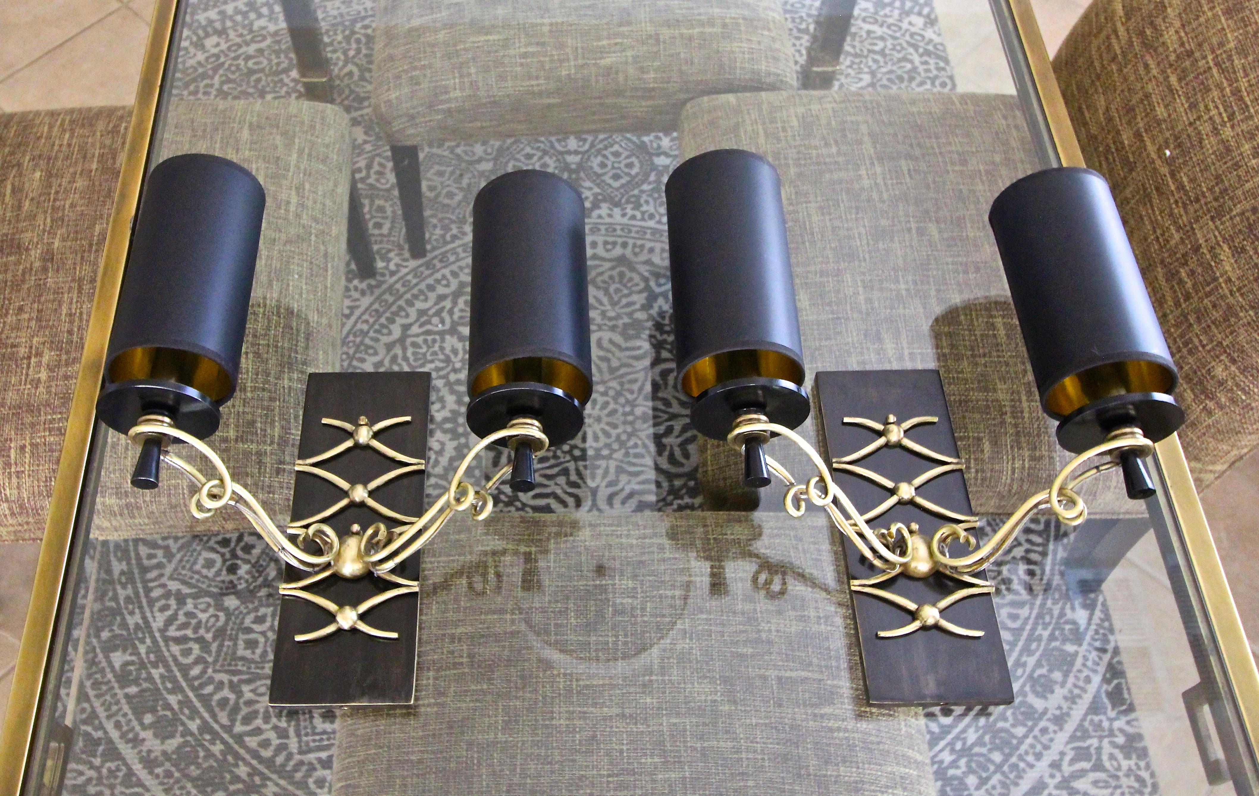 Pair of large French Jules Leleu style brass 3-arm wall sconces. Rectangular backplates are darkened brass (not paint) and modified to cover a US junction box. Each sconce uses 3 regular A-base bulbs. Newly wired for US. Measures: 17