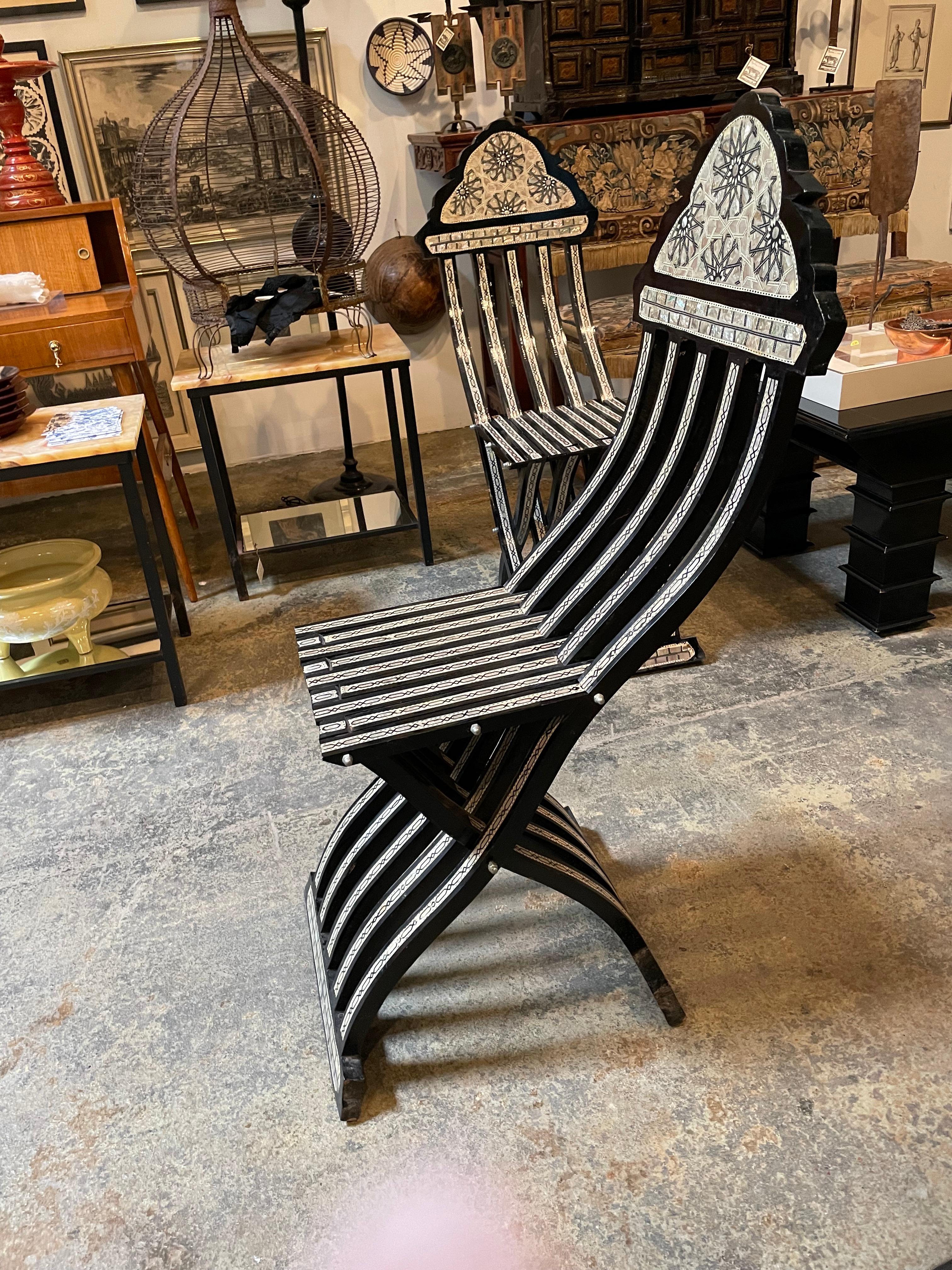 Unique pair of Levantine black and mother of pearl inlaid side chairs. Both chairs are intricately inlaid with lustrous mother of pearl in sophisticated details.
       