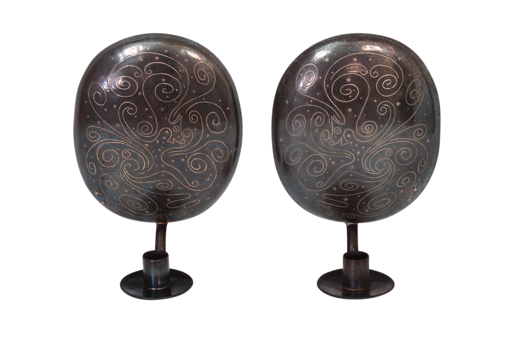 A rare pair of Los Castillo candle sconces in copper with swirling inlaid brass design, Taxco, Mexico.

Signed.