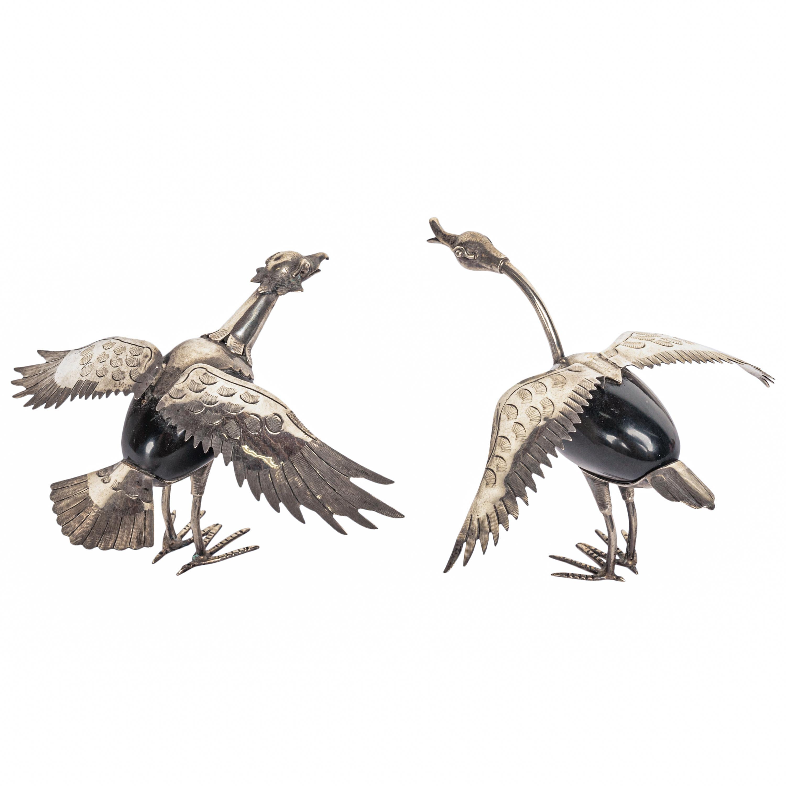 A pair of sterling silver & black onyx mid-century standing birds, Taxco, Mexico, circa 1950.
A wonderful pair of whimsical sterling silver engraved birds with egg shaped bodies made of black onyx, the birds with outstretched engraved wings and