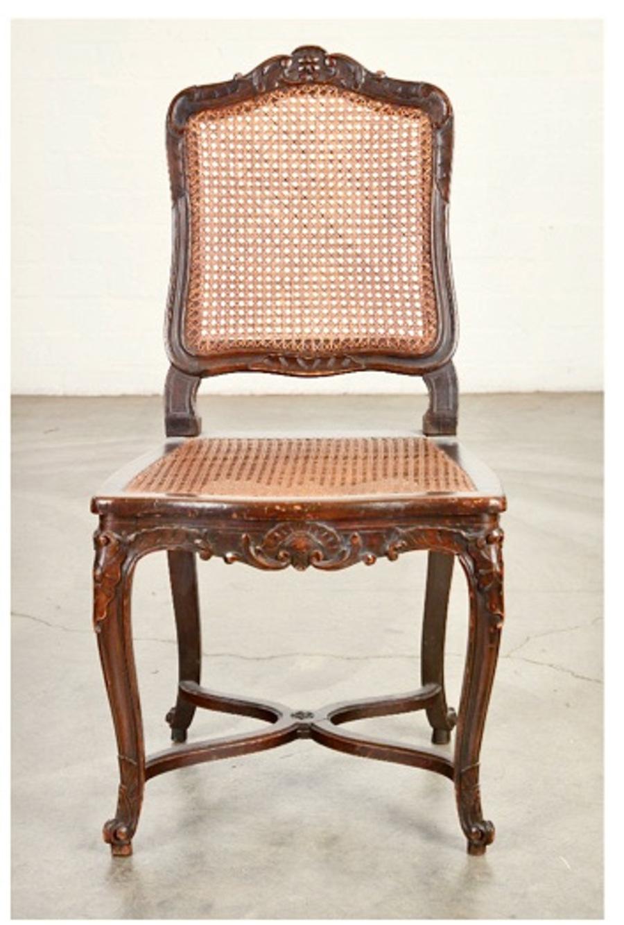 This is a classic pair of Regence or Louis XV-Style side chair. The frame is well-carved and the caned seats and backs are in good condition. Both chairs are sturdy and ready for another hundred years of use. The cushions are complimentary and can