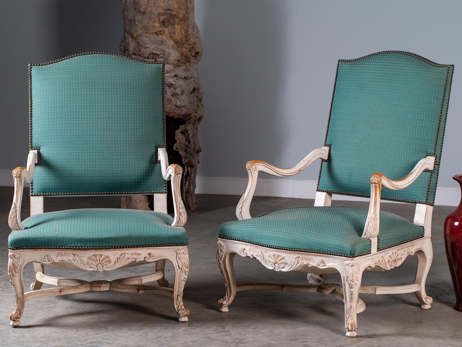A pair of vintage French Louis XV Régence style painted arm chairs circa 1920 known as 
