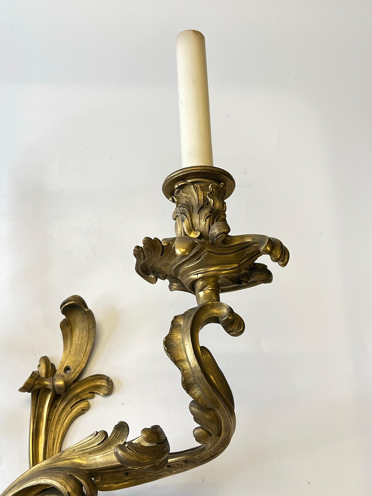 Pair of 19th century French Louis XV Rococo Style Gilt Bronze two light Sconces.