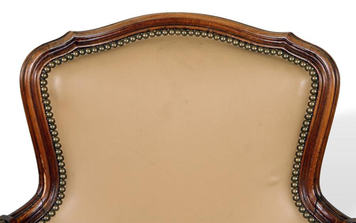 Carved Pair of Louis XV Style Cherry Bergere Chairs Recently Reupholstered in Leather