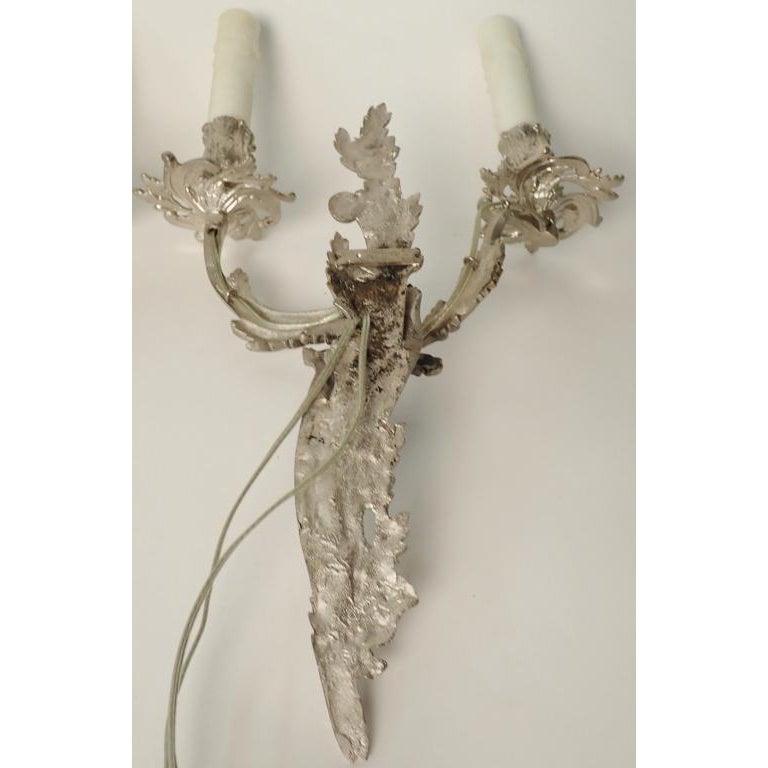 Pair of circa 1910 Louis XV style electrified wall sconces. Nickel over bronze. Fine quality and recently wired.