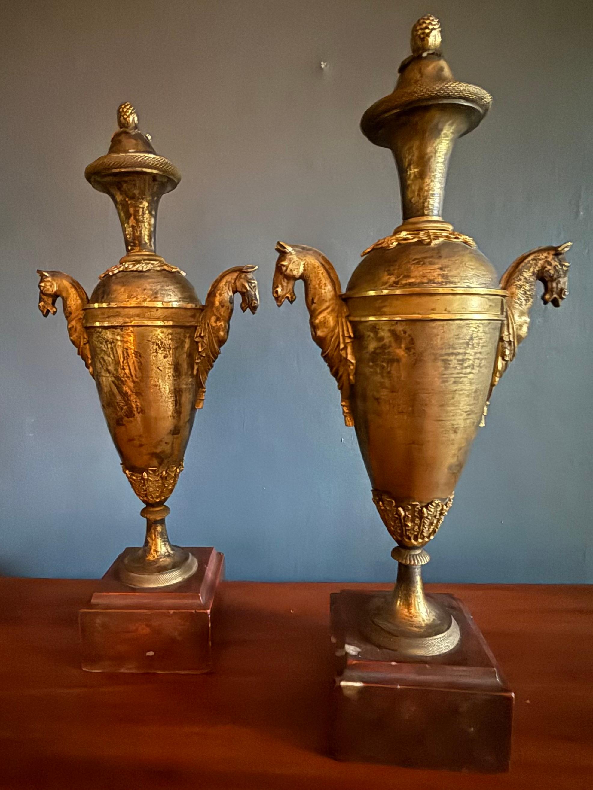 Pair Louis XVI  Ormolu Bronze Horse Handled Urn Candlesticks. French Empire-Directoire Period patinated urn form candlesticks with ormolu mounts, Ottoman influenced horsehead handles, pomegranate knopped lids reversing to bobeche for candles all on