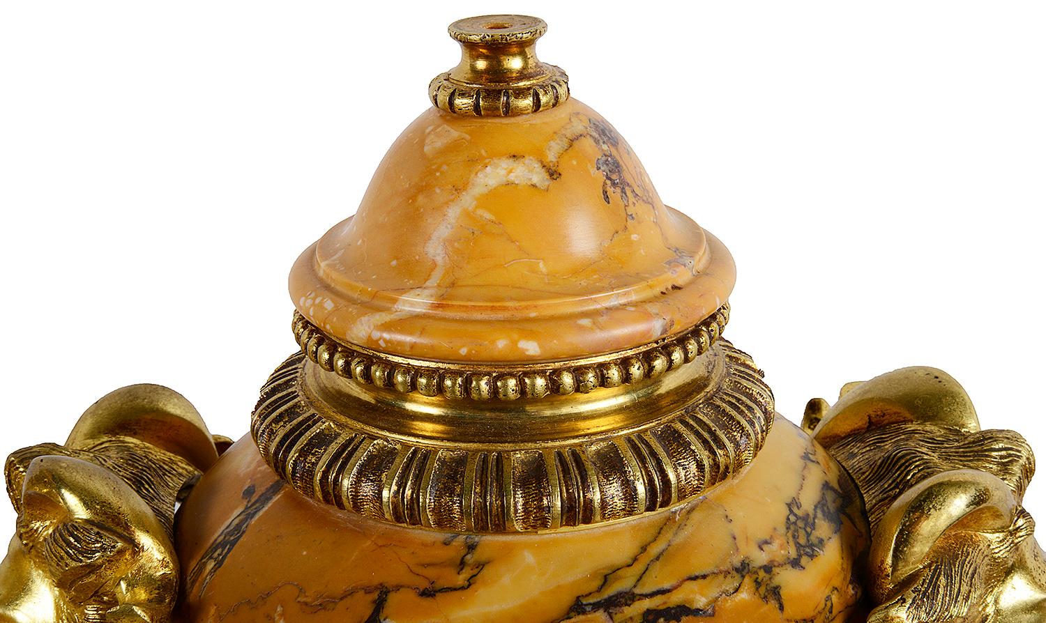 A good quality pair of late 19th century French Louis XVI style Sienna marble lidded vases, each with gilded Ormolu mounts, swags and masks. Measures: 52cm (20.5
